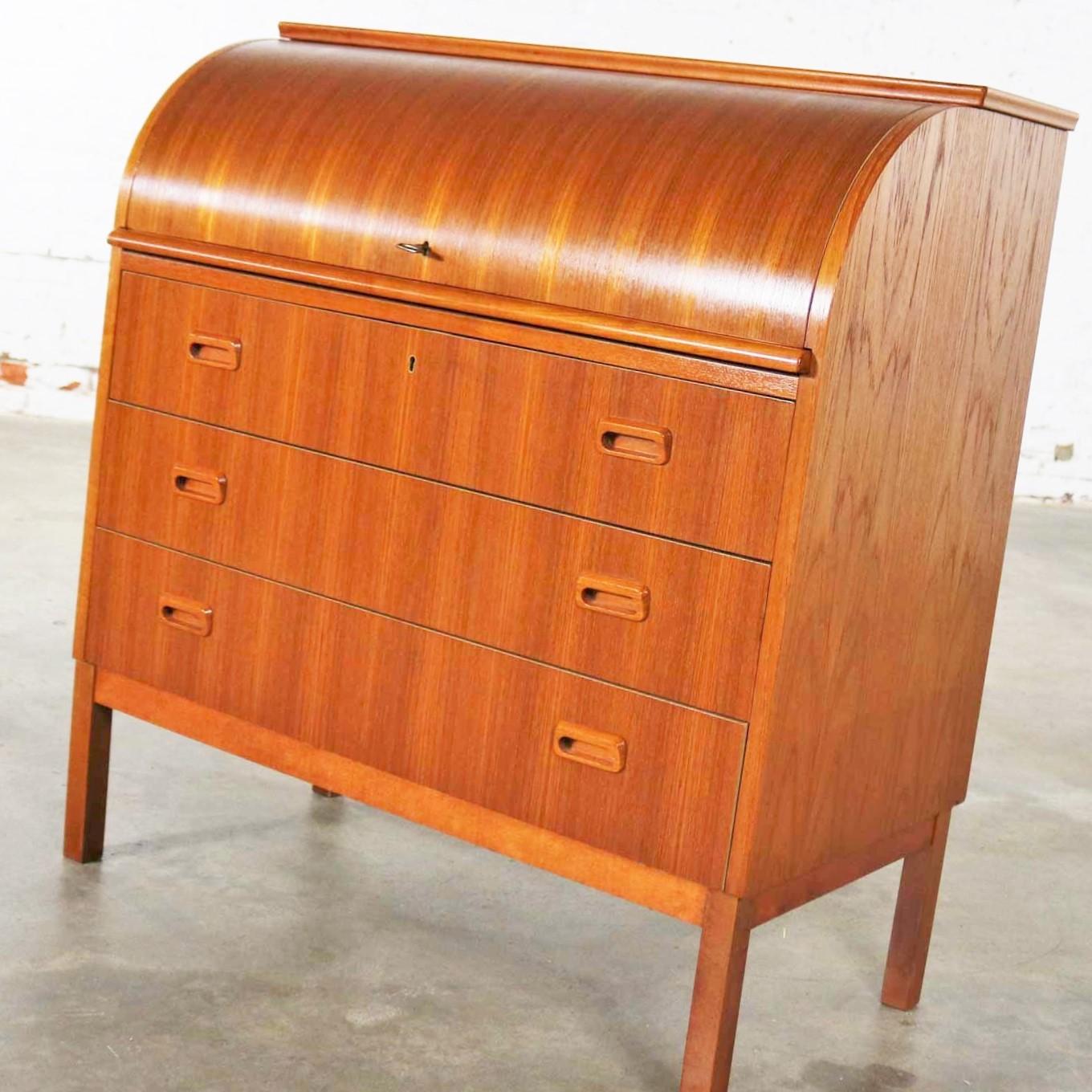 Handsome teak Scandinavian Modern rolltop writing desk or secretary which is attributed to Egon Ostergaard. It is marked Made in Sweden and in wonderful vintage condition and no outstanding flaws we have detected only small age appropriate
