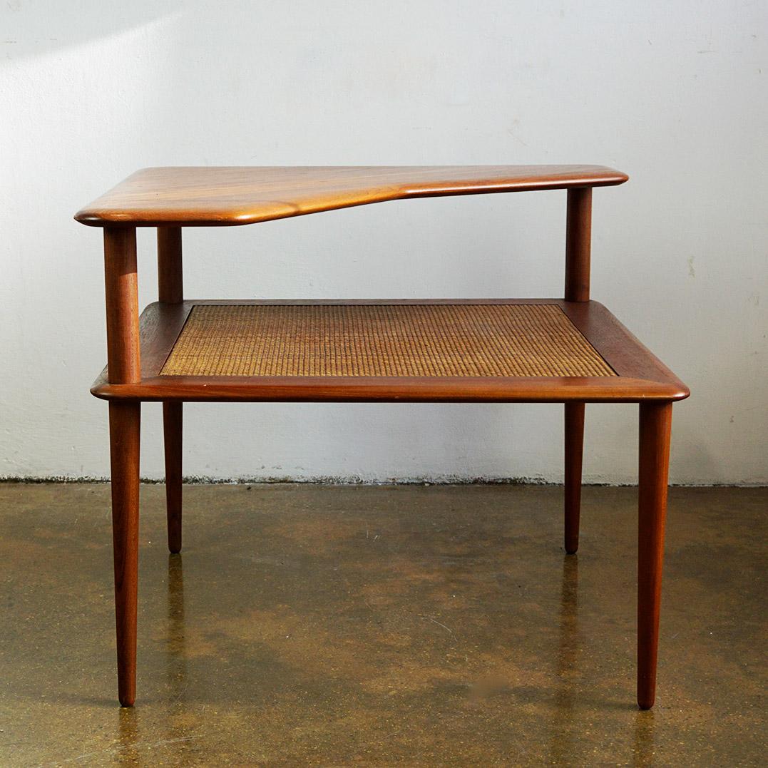 This rare, two-tiered Minerva teak corner side table was designed by the iconic design duo Peter Hvidt  and Orla Mølgaard-Nielsen.  
This artfully crafted table is made from solid teak  and will be perfect for those searching for an authentic,