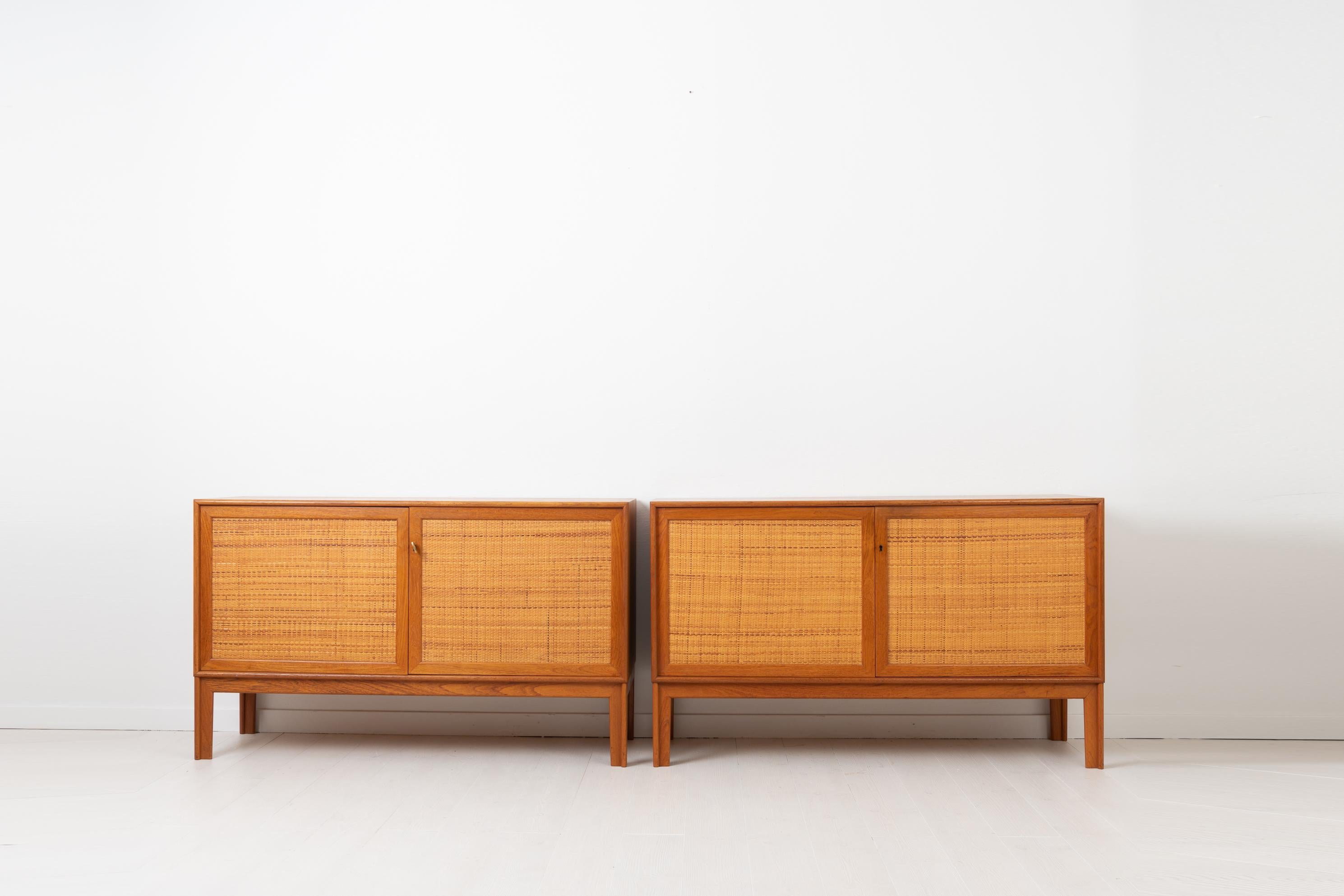 Teak sideboards by Alf Svensson for Bjästa Snickerifabrik in Sweden. This pair of sideboards are from the mid-20th century and a prime example of the Scandinavian Modern style. Doors dressed in rattan. Designed and manufactured during 1960s, both