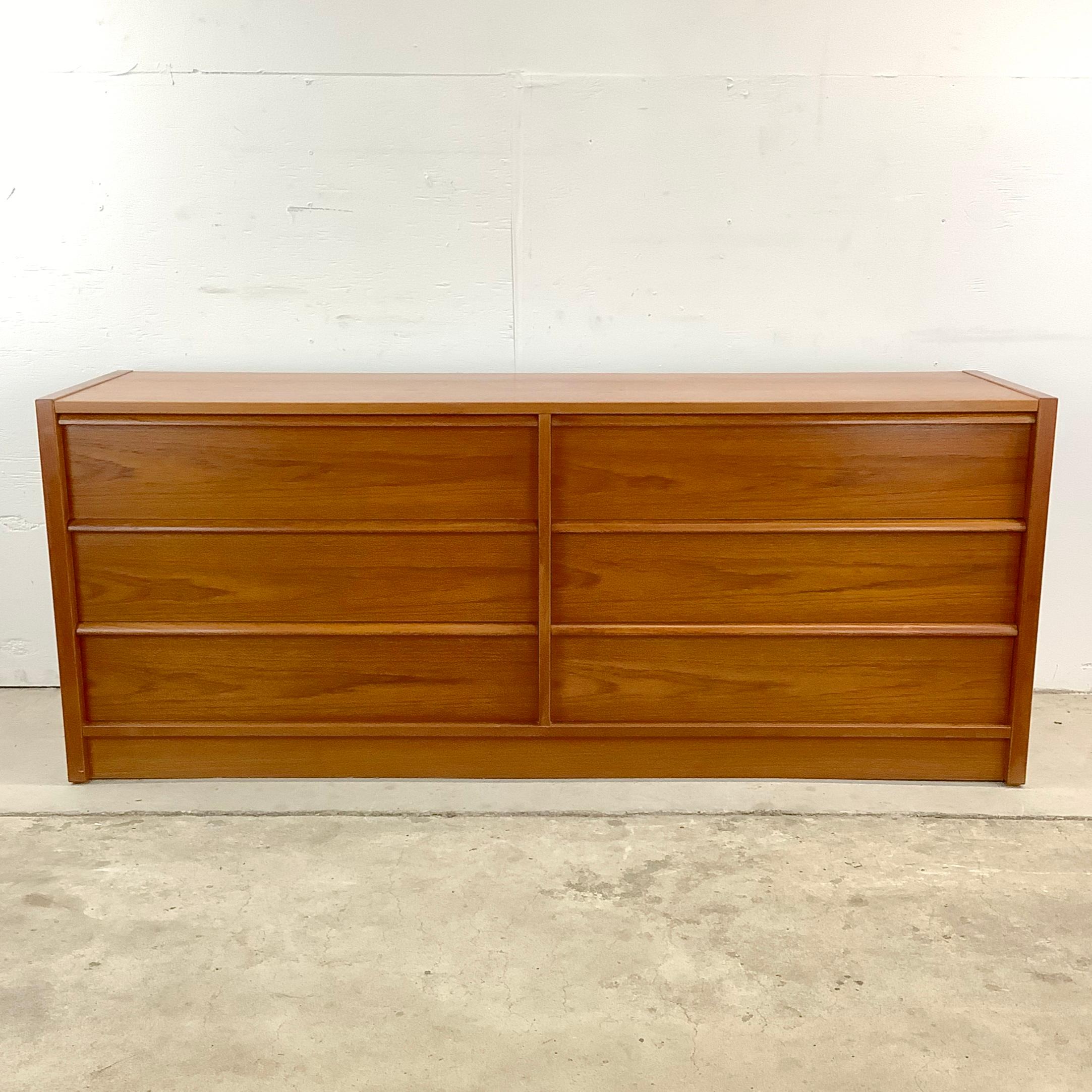 Discover the epitome of Scandinavian modern design with this Vintage Danish Modern Six Drawer Double Dresser, a piece that captures the essence of Nordic elegance and functionality. Impeccably crafted with a keen eye for clean lines and minimalistic