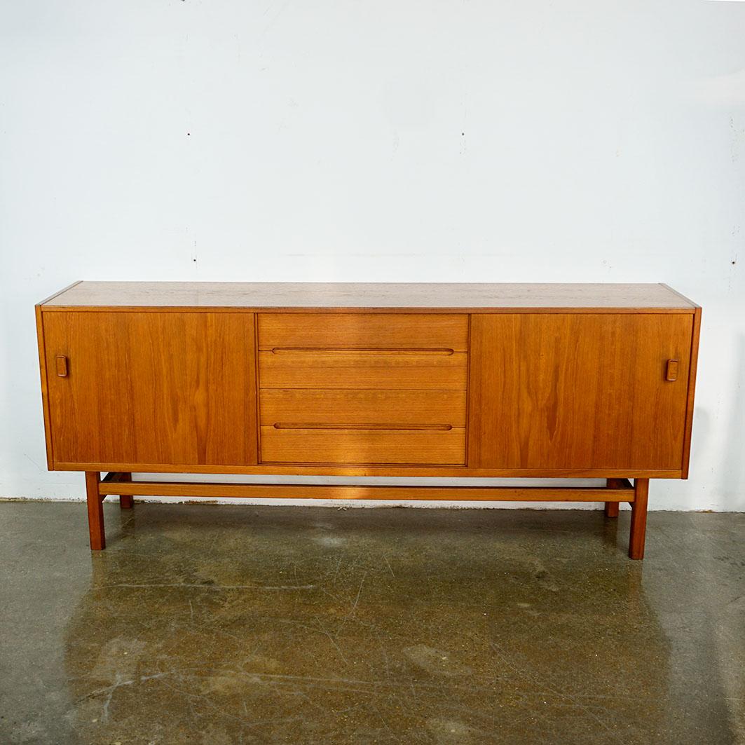 This excellent scandinavian modern sliding door credenza or sideboard has been designed by Nils Jonsson for Troeds, Sweden 1960s- 
It features four drawers and two sliding doors. One of the drawers for cutlery, beautiful slightly restored condition.