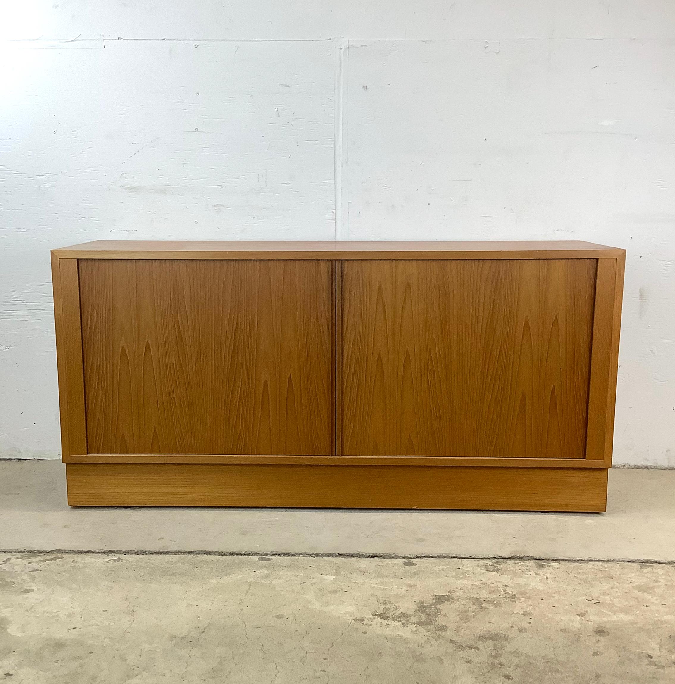 This Vintage Teak Office Credenza is a sophisticated blend of Scandinavian modern design and timeless elegance, crafted with exquisite teak finish. This vintage office credenza embodies the essence of mid-century Danish charm, with its sleek lines