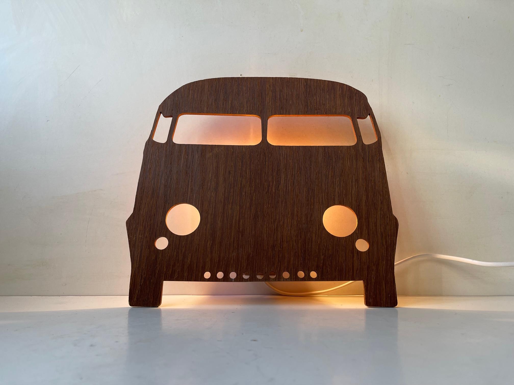 A curious set of wall lights. One in shape of a house and one in shape of Volkswagen Iconic Kombi bus. They are fashioned from teak veneer and features porcelain sockets and on/off switches to their cords. Measurements: H: 35/25 cm, W: 27/28 cm,