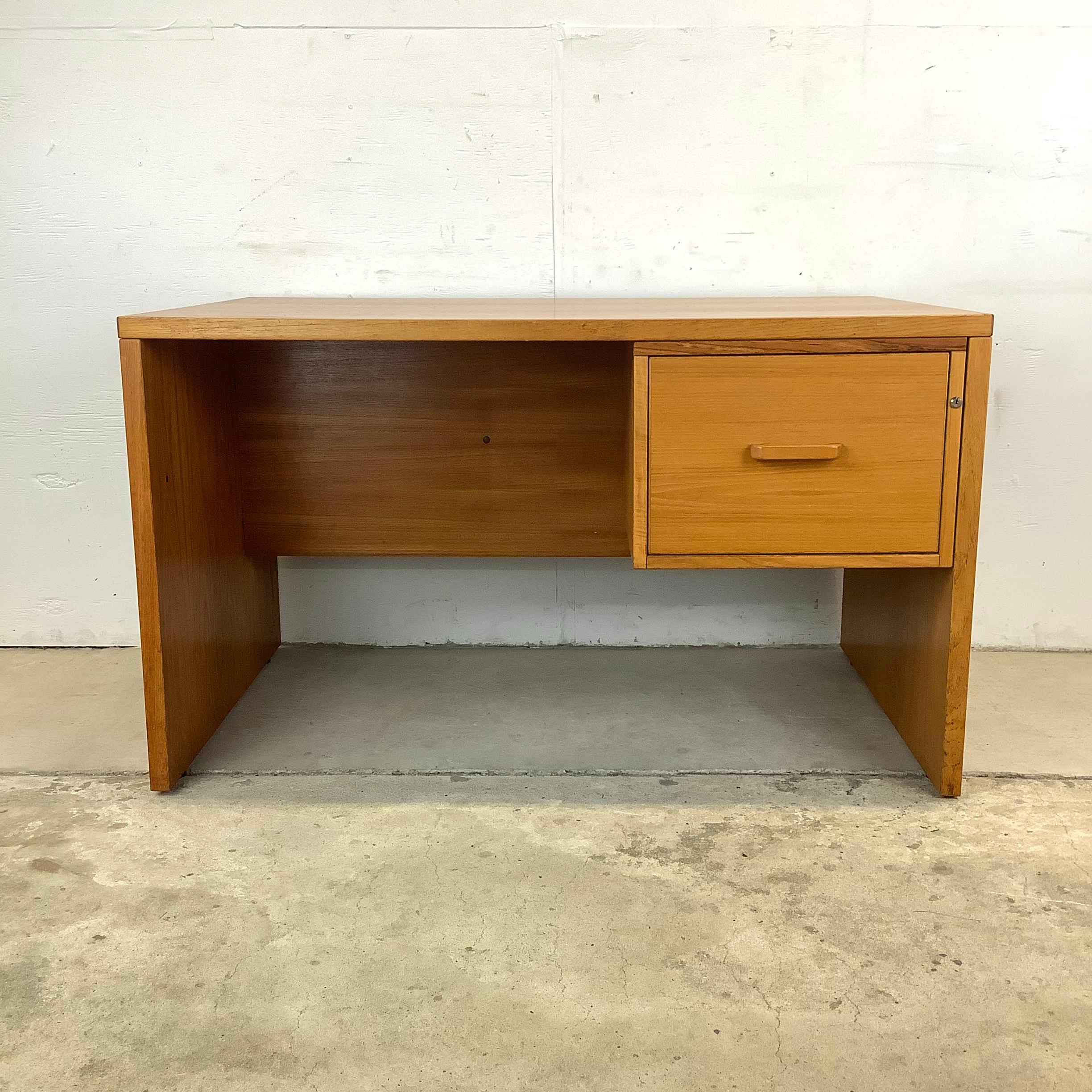 Introducing an exceptional vintage centerpiece for your workspace – this Scandinavian Modern Teak Desk. Drawing inspiration from iconic mid-century Danish design, this desk embodies the essence of Scandinavian style, blending simple elegance with
