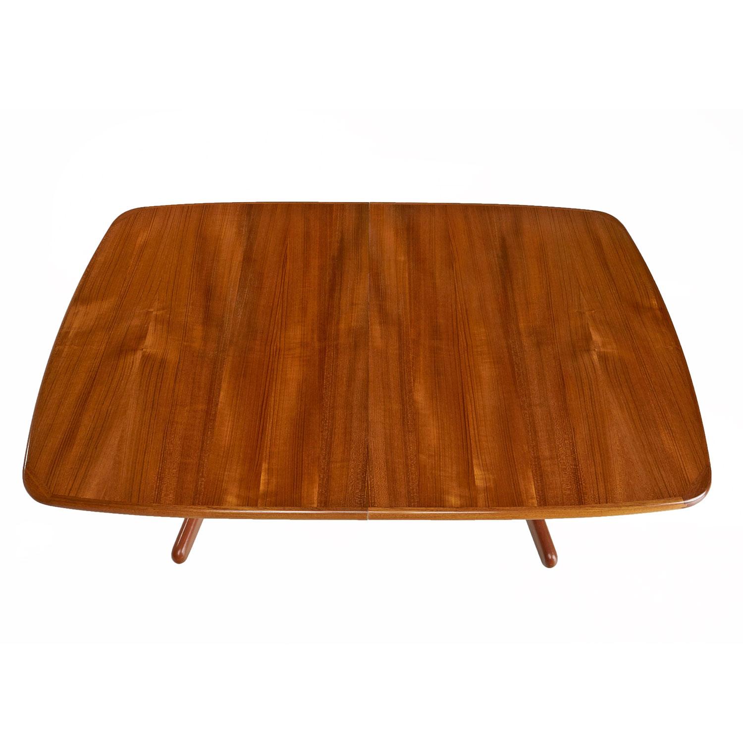 Vintage Danish teak trestle base dining table with two table leaf inserts to expand length. This table has a beautiful tiger stripe effect to the decades old teak wood. This versatile table allows one to customize the length by using the table at