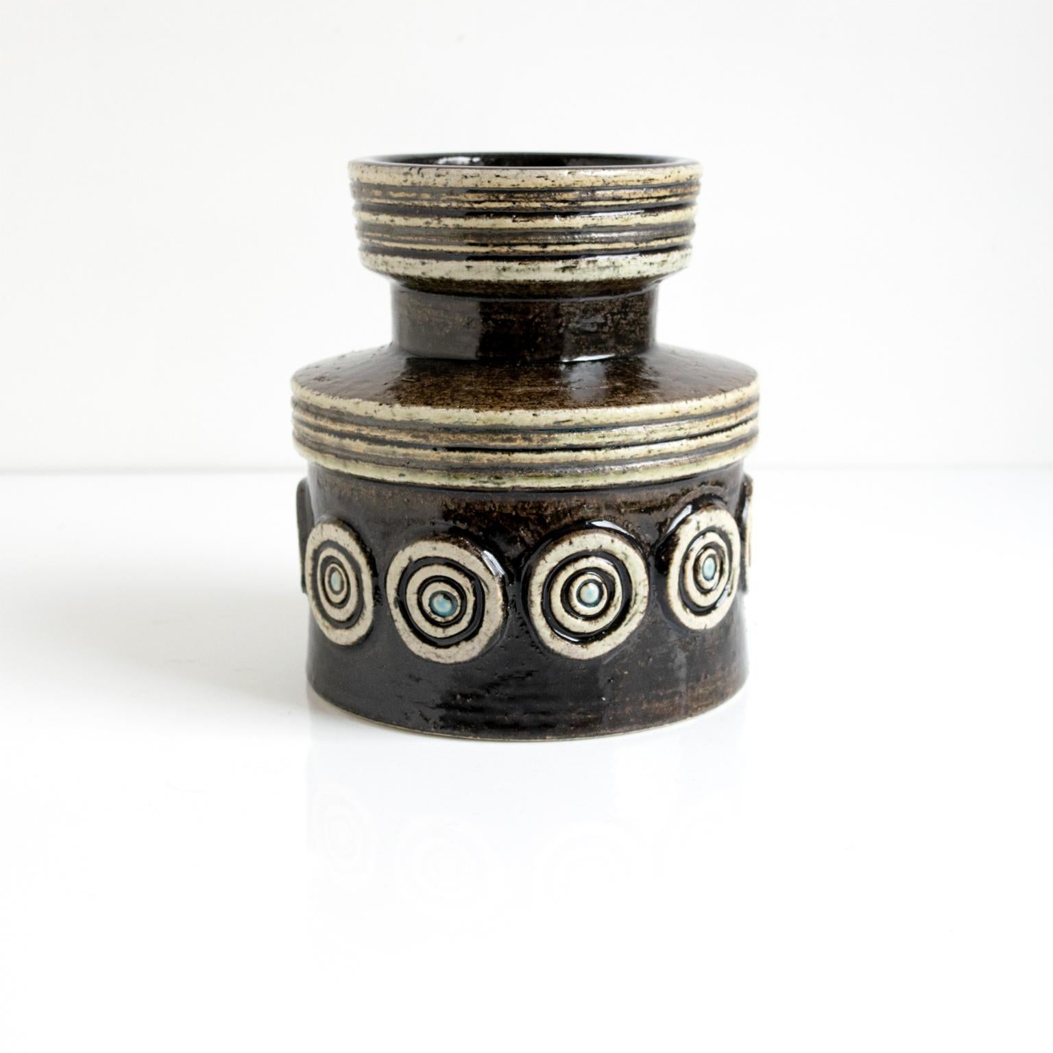 A Scandinavian modern vase by Britt-Louise Sundell for Gustavsberg, circa 1960. The vase has row of dotted circles on an earthy glaze, a textured surface and a shiny blue glaze inside.

Measures: Height 6.5