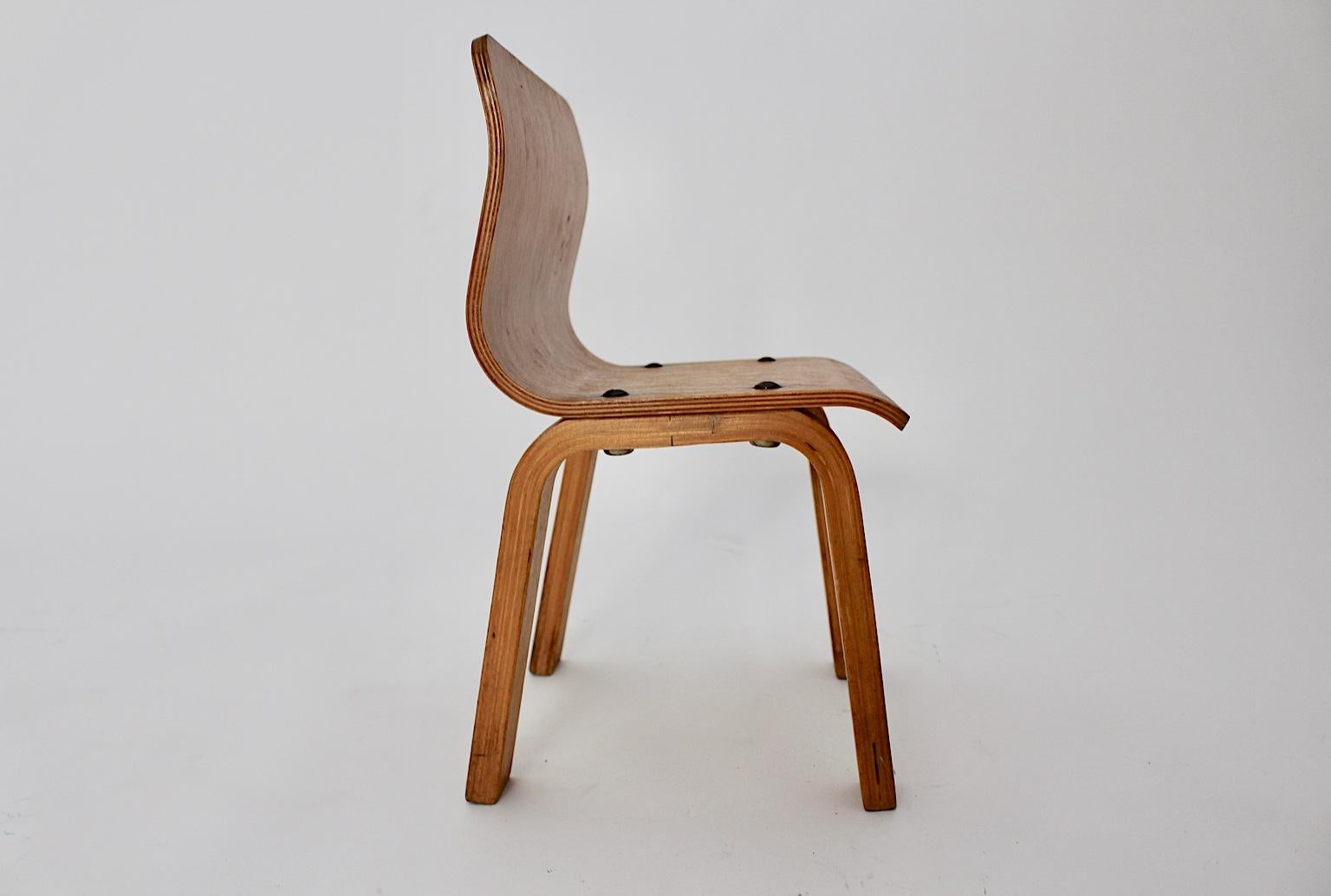 Scandinavian modern birch vintage children chair in clear design, which was produced in the 1950s.
The birch plywood seat shell is connected with metal screws onto the curved legs.
Also the children chair is carefully cleaned and in very good