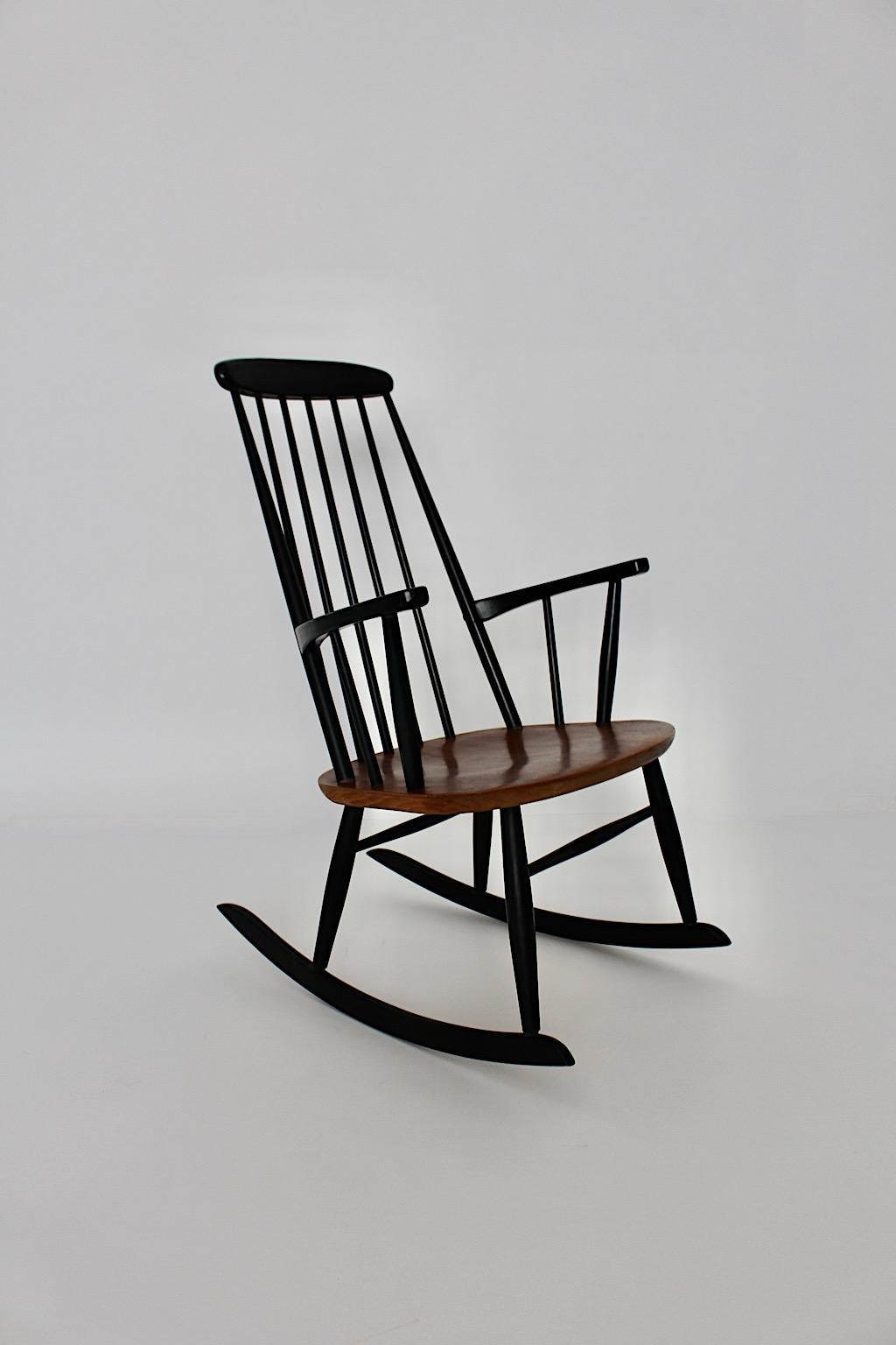 Scandinavian Modern vintage rocking chair from teak in brown and black color by Ilmari Tapiovaara for Asko, Finland 1950s Finland.
An amazing vintage rocking chair in sleek design in warm colors as brown and black.
This rocker could inject some