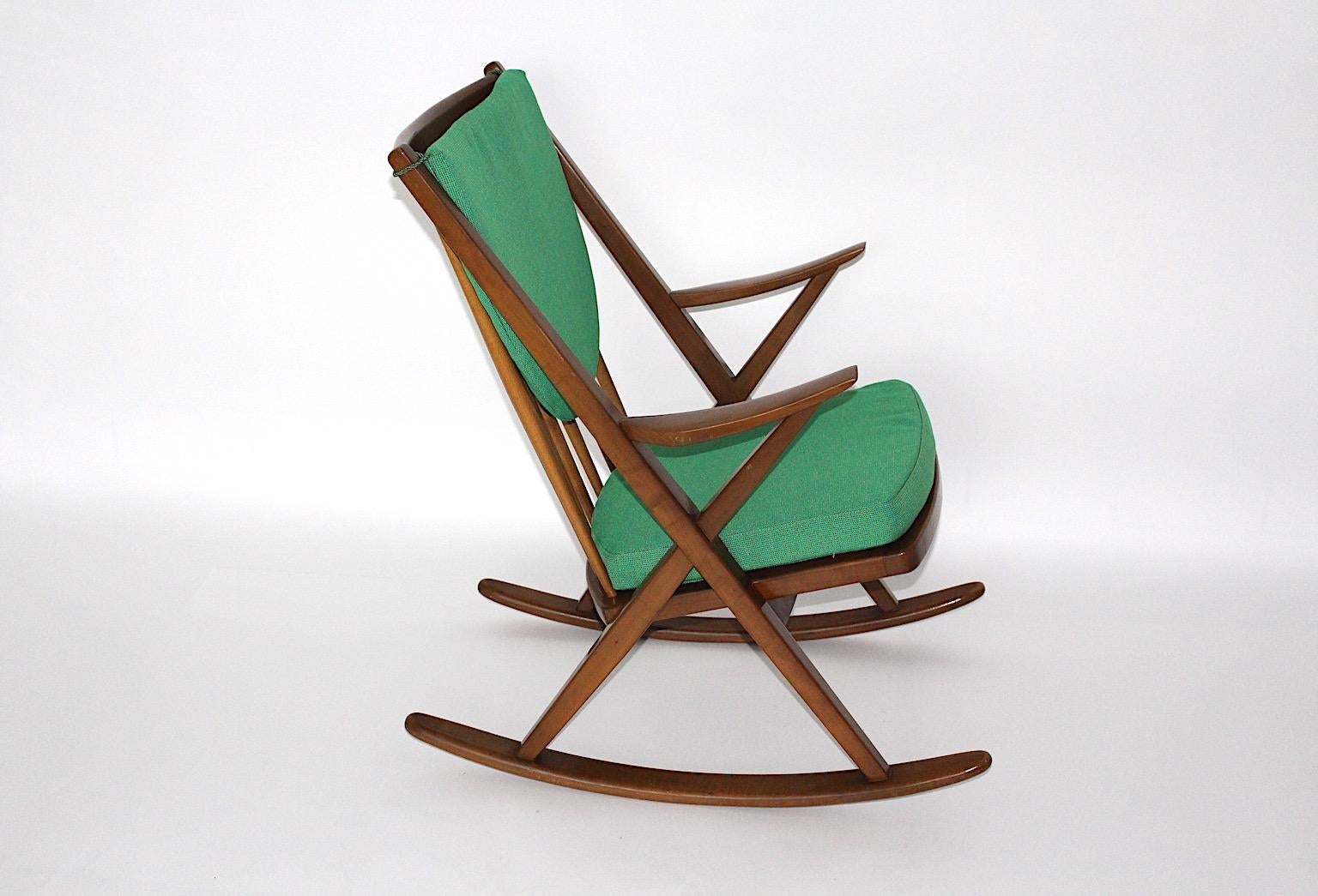 Scandinavian Modern vintage rocking chairs from beech with renewed green loose cushions by Frank Reenskaug from Bramin Mobler  circa 1960 Denmark.
A fabulous duo rocking chairs from beech in a warm brown color and renewed loose cushions from green