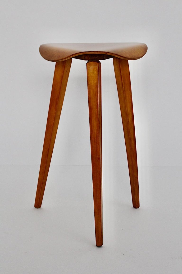 Scandinavian Modern vintage sculptural and organic tree legged stool from birch veneer and plywood 1950s.
The tree legged stool with shellac polished surface by hand demonstrates a stunning warmth and golden wooden color tone.
The top shows a