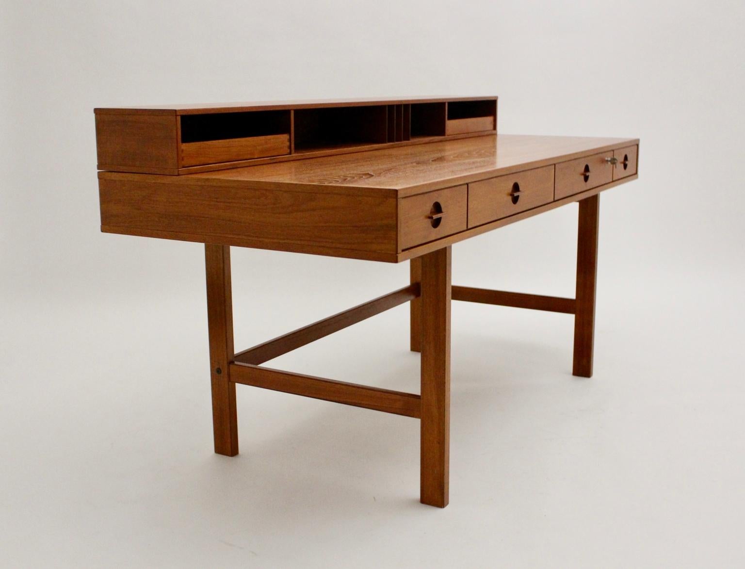 This presented Scandinavian modern vintage teak writing table or desk was designed by Jens Quistgaard, circa 1969 and executed by Lovig Dansk.
This vintage teak flop top partner desk is very functional. You are able to fold it at one side for using