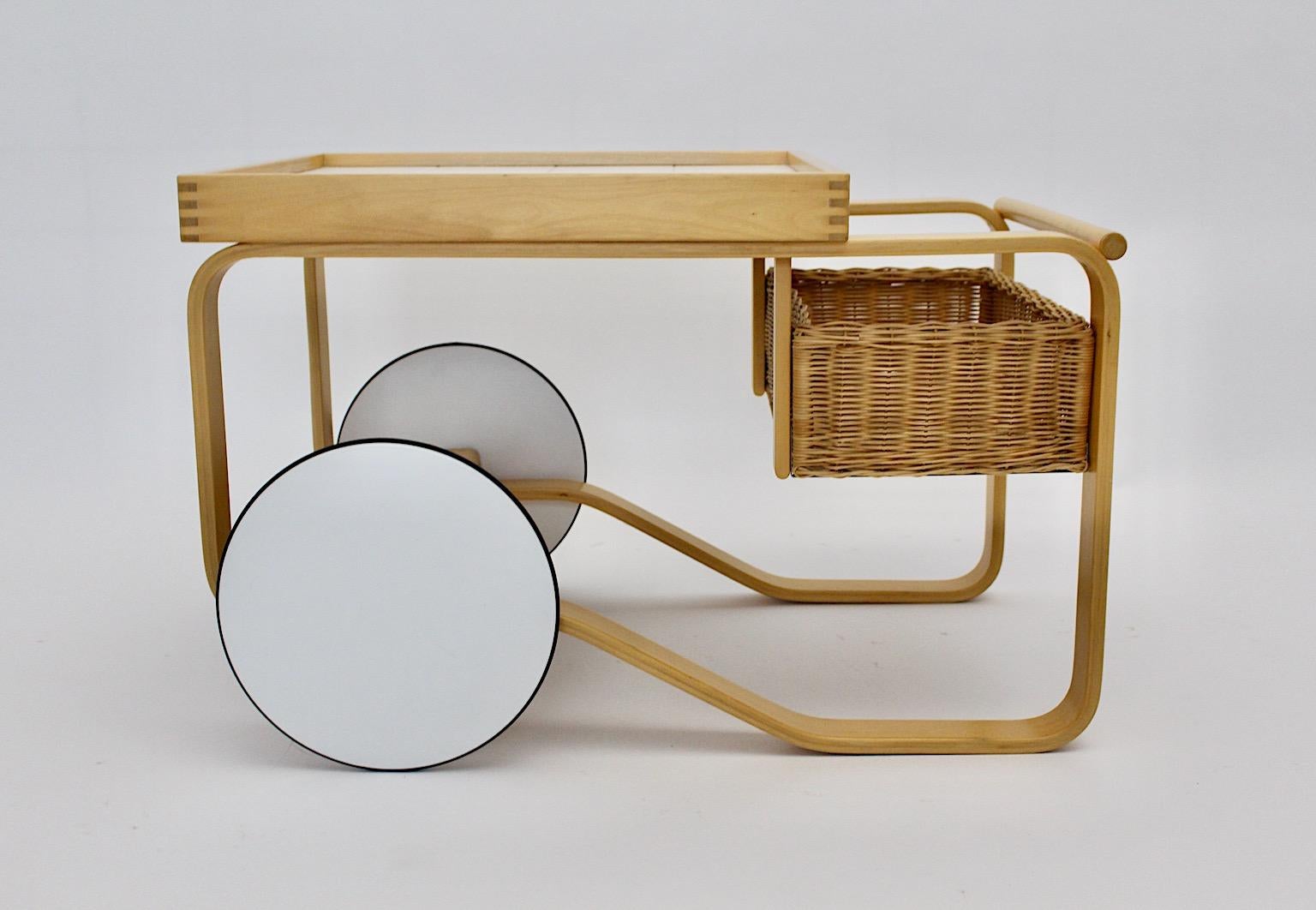 Scandinavian modern Oorganic vintage tea cart 900 by Alvar Aalto for Artek designed 1937 Finland and manufactured 1980s.
A wonderful timeless tea cart or bar cart by Alvar Aalto model 900 from birchwood with white tiles, white wheels and a willow