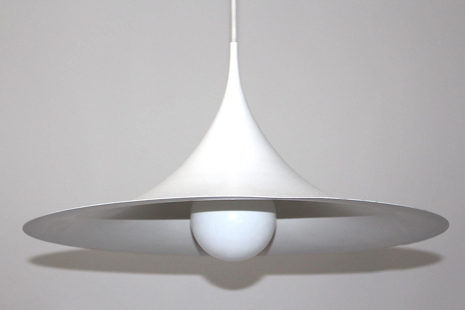 Scandinavian Modern vintage Semi chandelier or pendant from white enameled metal attributed to Claus Bonderup & Torsten Thorup 1967 for Fog & Morup.
The chandelier in trumpet form stands out through its timeless form and works very well with