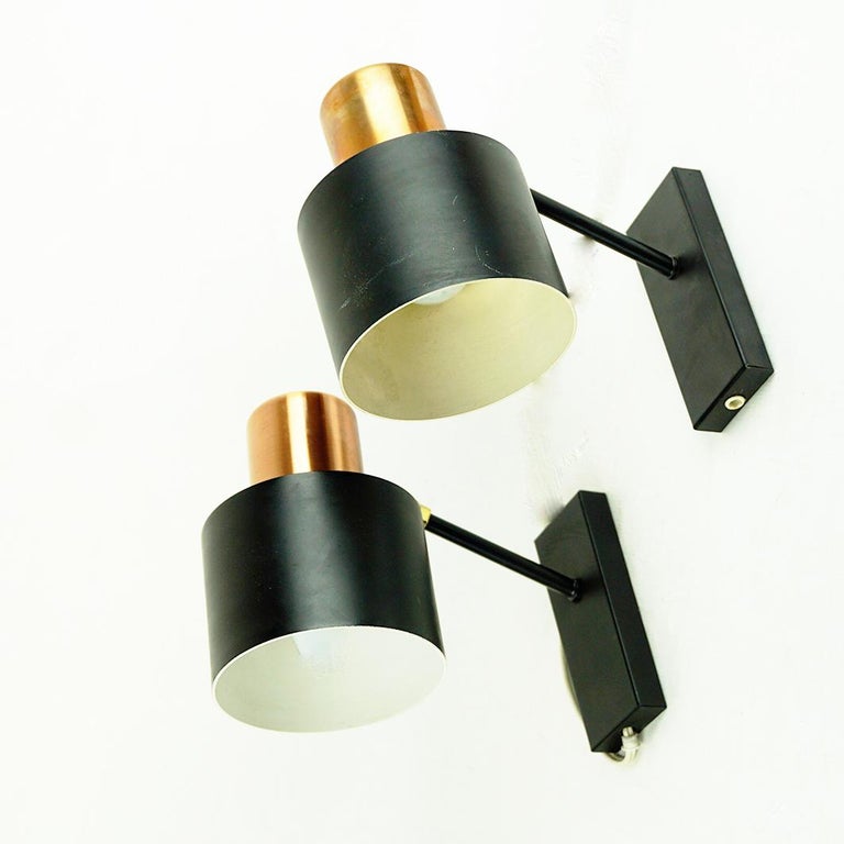 This iconic scandinavian Modern Pair of Alfa wall lights or sconces have been designed by Jo Hammerborg for Fog and Mørup, Denmark, 1966. It is made of copper, brass and black lacquered metal and features an adjustable shade.
Jo Hammerborg was