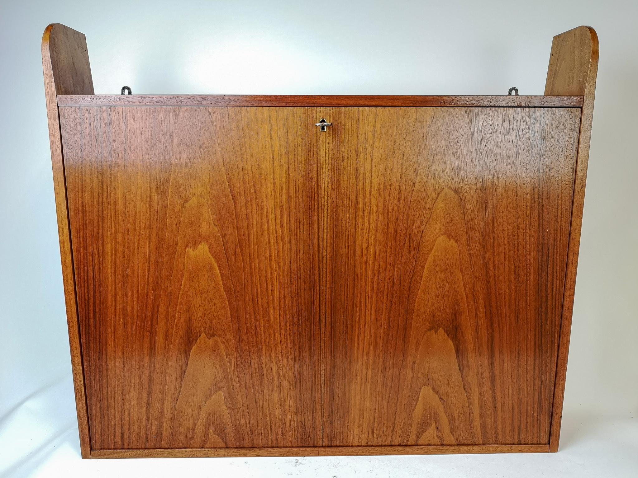 This wall-mounted small storage cabinet for the office was produced in Sweden and made in teak. 

Good condition, small dents. 

Measures H 66, W 75, D 13 cm.