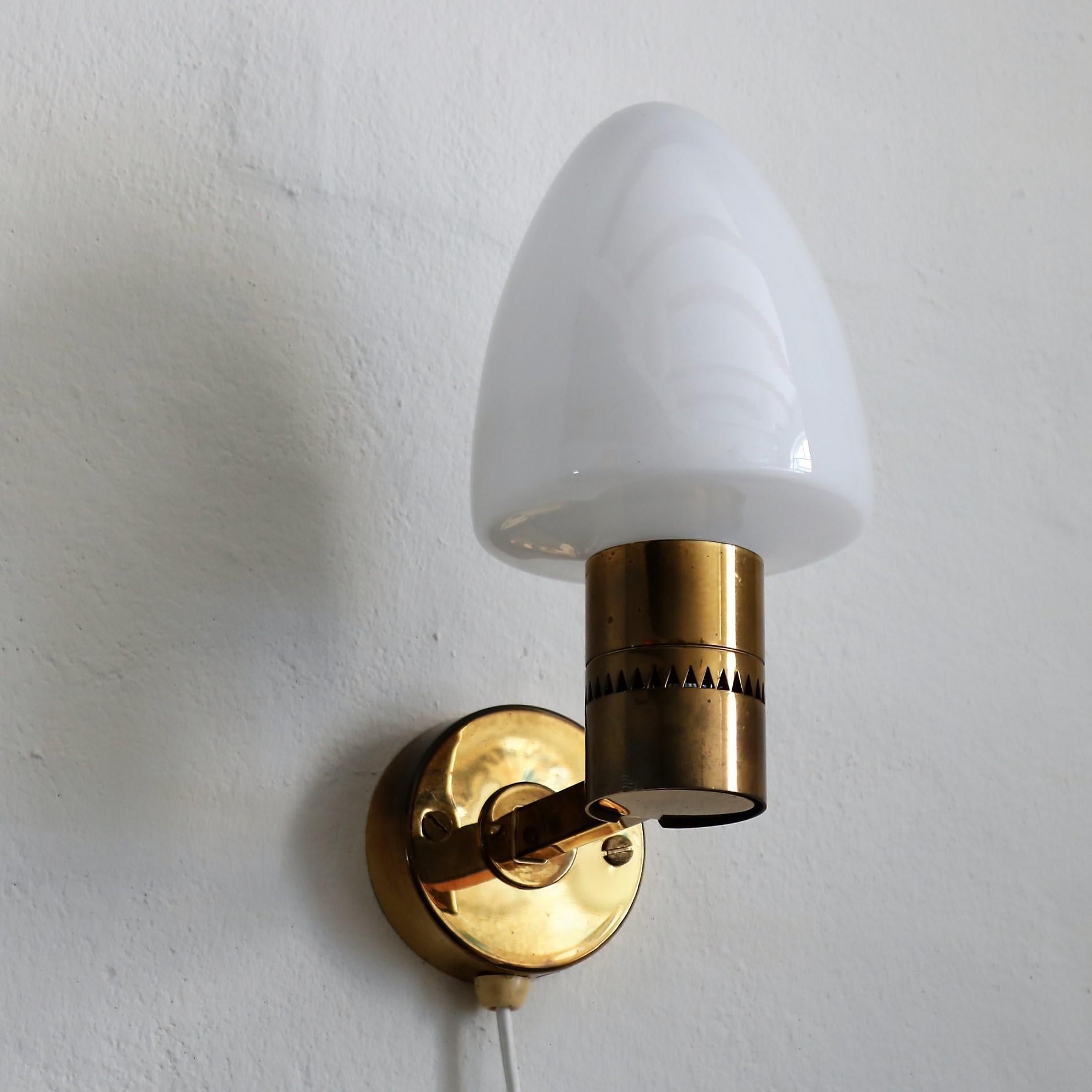 Wall sconces designed by Hans Jakobsson and manufactured in the 1960s by Markaryd. Made in brass and milky white opal glass.