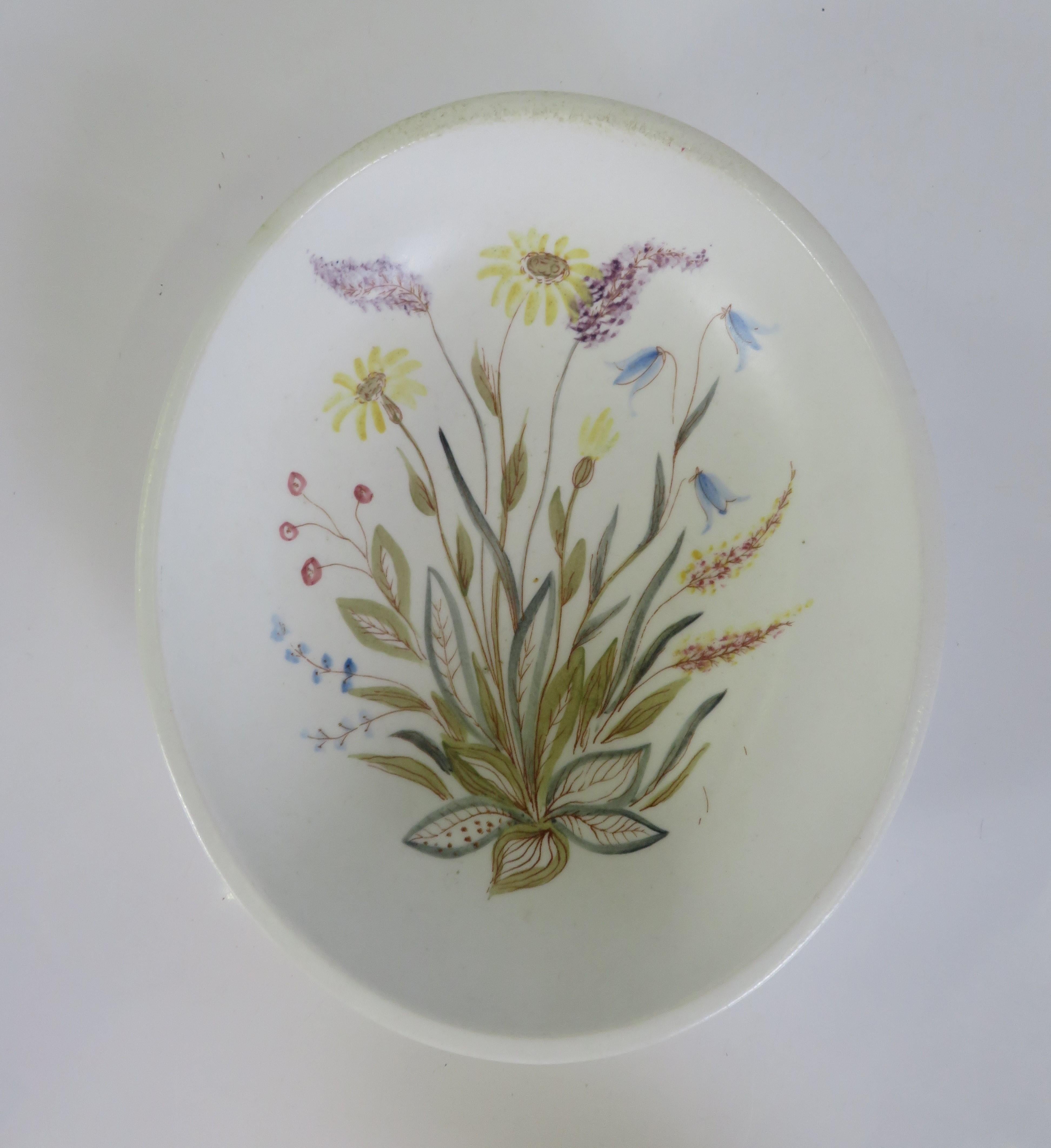In the 1940s, Lars Thoren (1918-2006) created a collection of white stoneware pieces for Rorstrand named “Vilda Blommor” or “Wildflowers”. The pieces had hand-painted decor of colorful flowers that grew in the meadows of Sweden like heather,