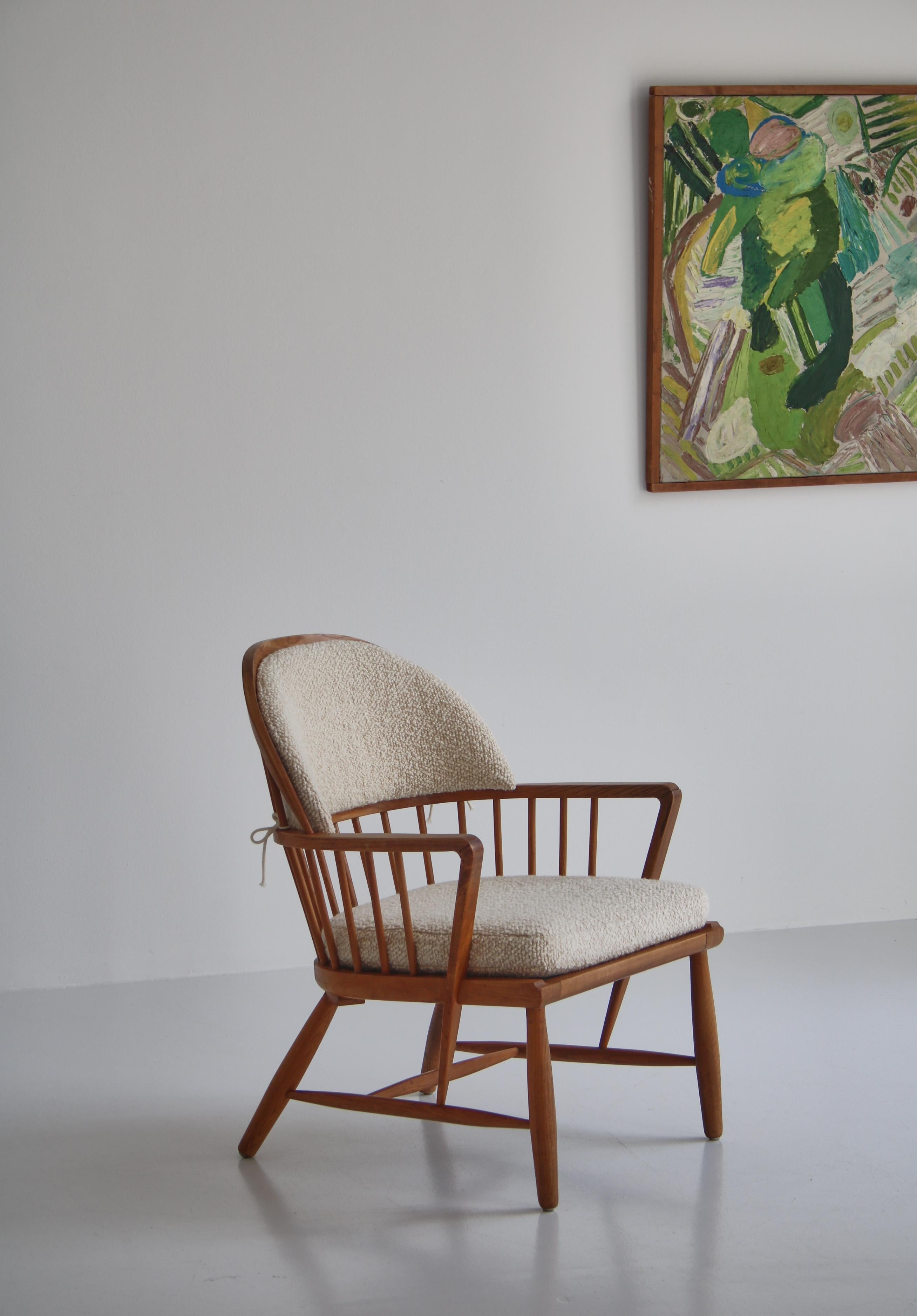 Windsor armchair by Danish cabinetmaker made in the 1940s. The chair is made from solid ash and is sublimely built with many wonderful details showing great craftsmanship. The original cushions have been reupholstered in chunky white boucle from