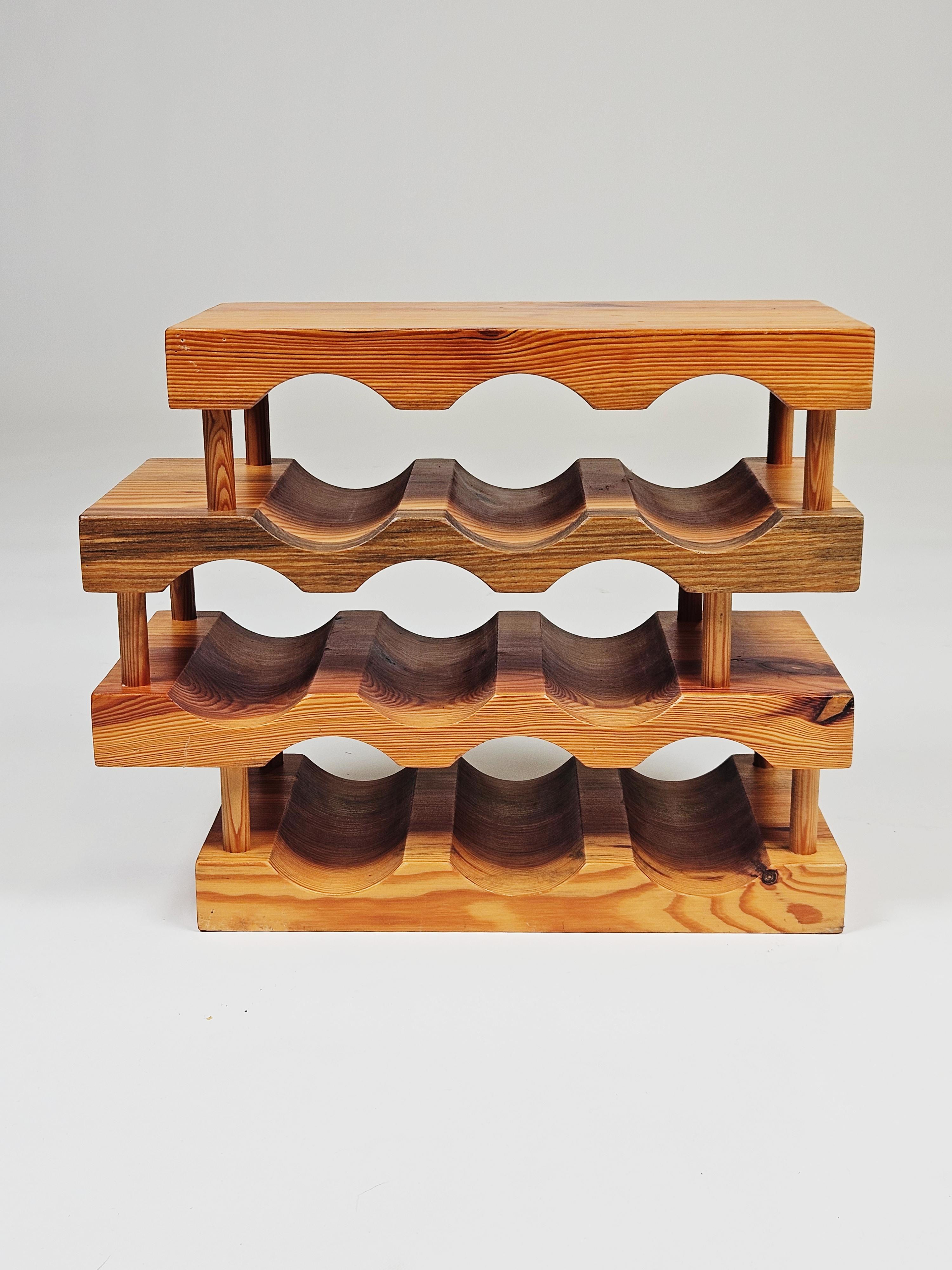 Solid pine wine rack designed by Stig Johnsson and produced by Smålandsslöjd, Sweden, during the 1970s. 

Goes perfectly with other furniture from the Scandinavian modern-period. 

Room for nine bottles. 