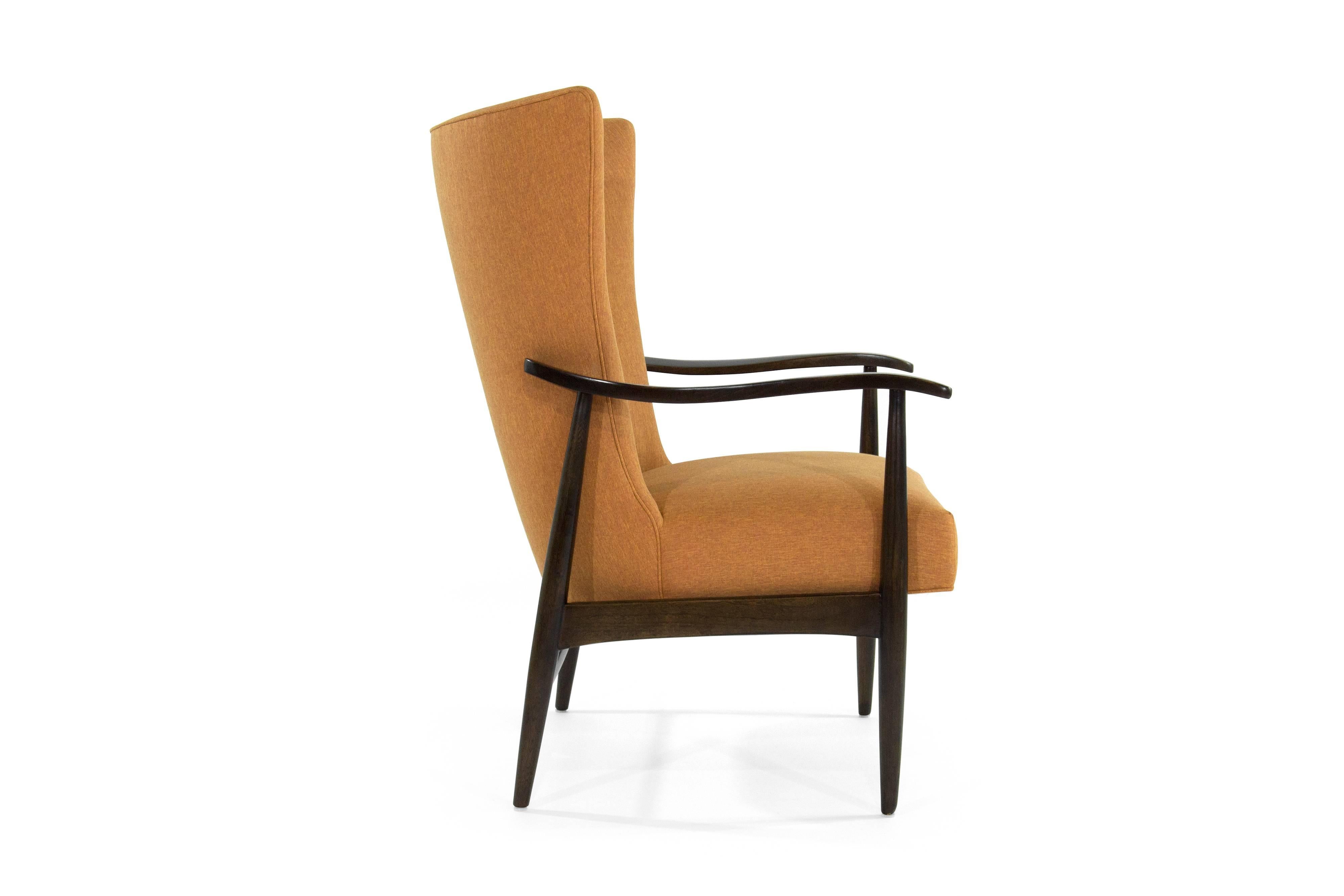 Wingback lounge chair made in Denmark, circa 1950s. Newly upholstered in linen; sculptural teak framing fully restored. Perfect in a bedroom setting, office or library.