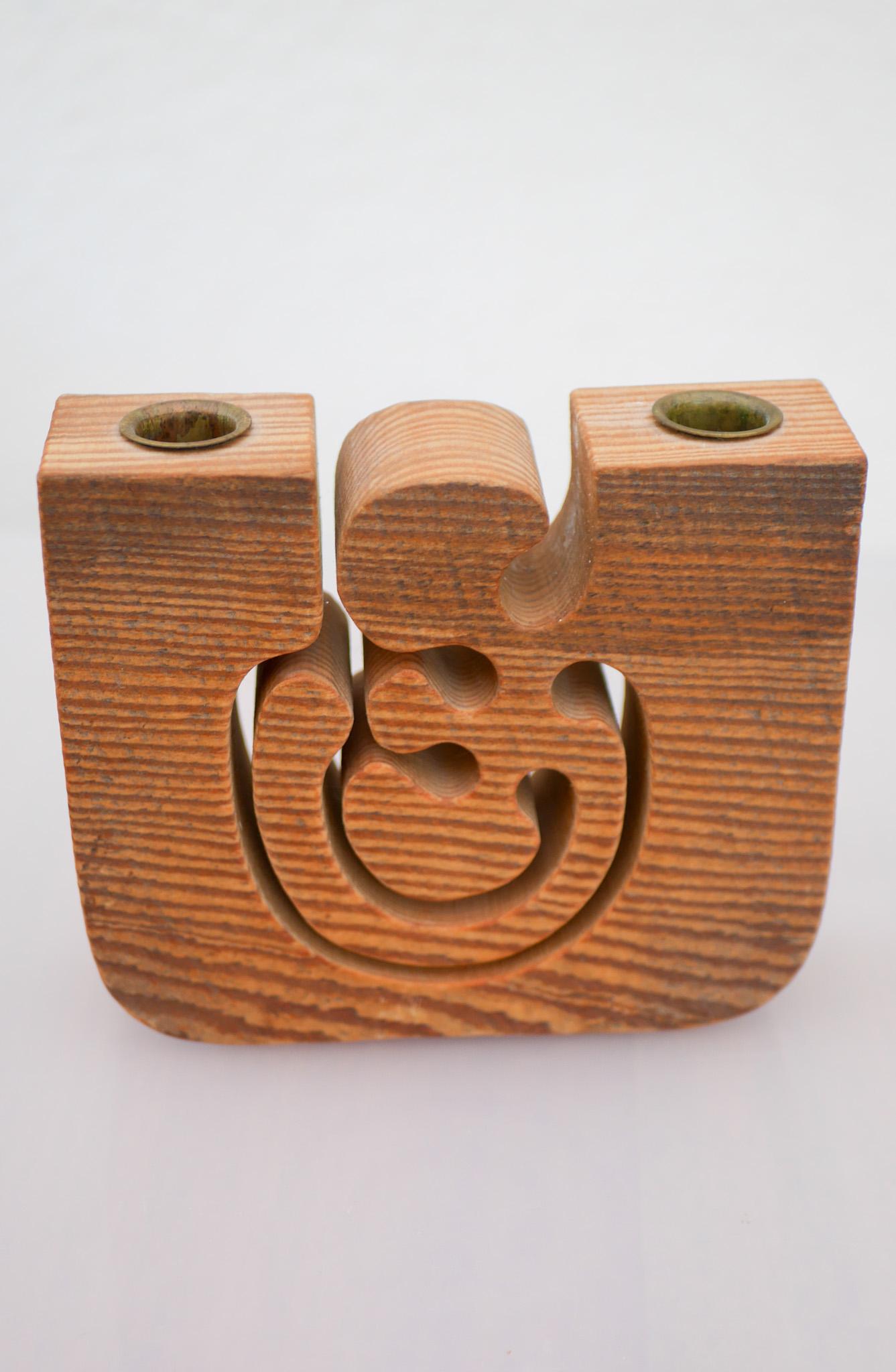 A rather large and unusual and rare Swedish Mid-century modern handmade candleholder, which is also a figurative abstract sculpture. It is made out of one solid piece of wood with intricate and organic shapes, with the possibility of holding two