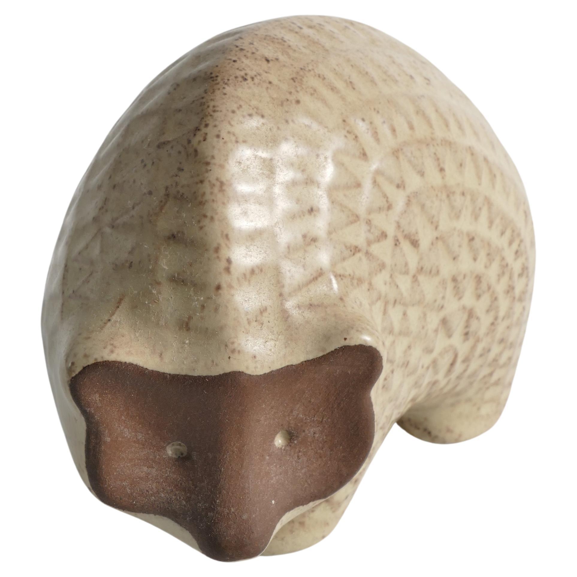This Scandinavian Modern earthenware hedgehog from the 1960s exudes charm with its glazed zigzag pattern on beige fur. The unglazed brown face adds a distinctive touch to its features, creating a harmonious blend of whimsy and natural