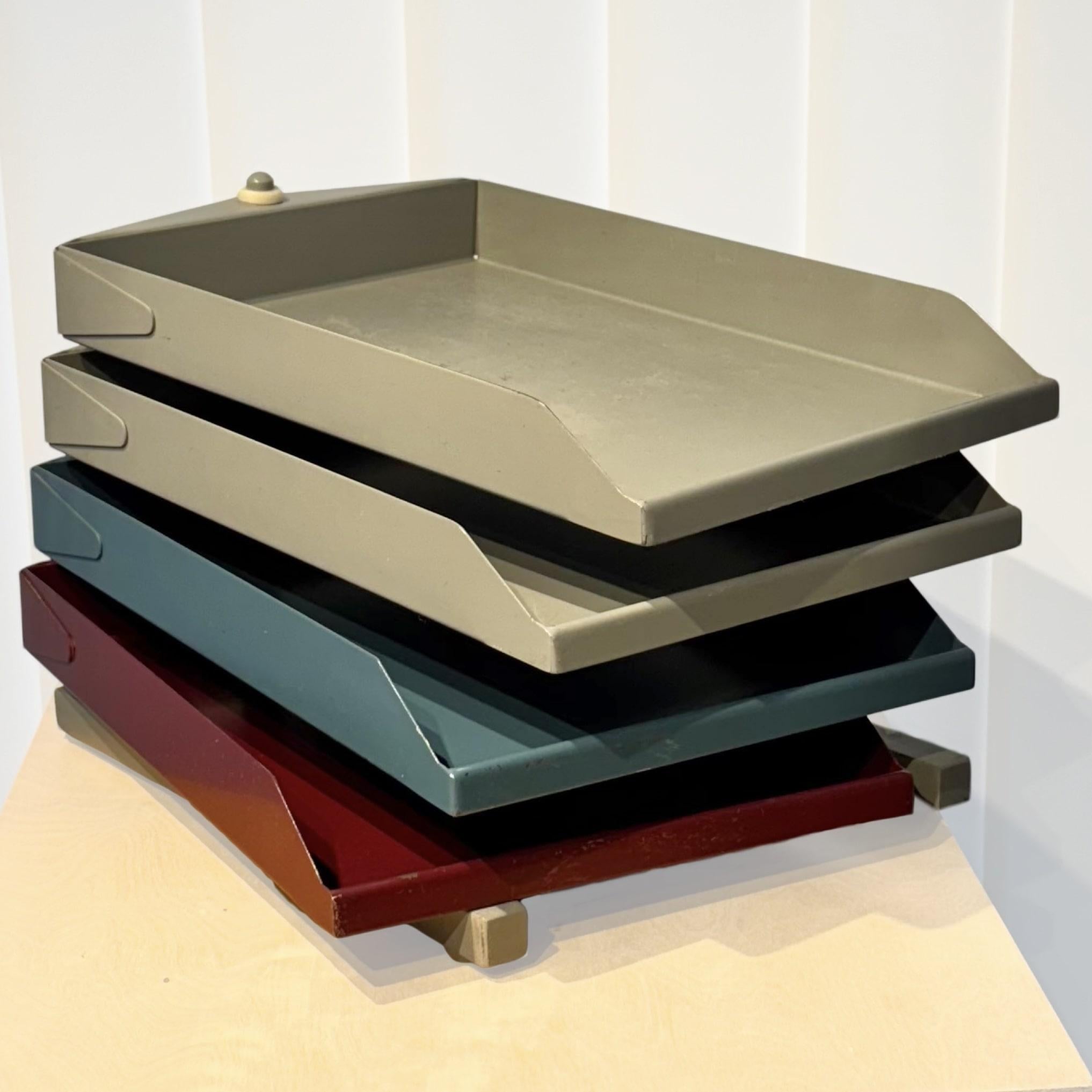 A modernist file organizer produced in the mid 20th century by Swedish industrial company Y. Bengtssons Mekaniska Verkstad once located in the small town of Motala. Featuring a sturdy metal construction with four trays painted in red, blue and gray.