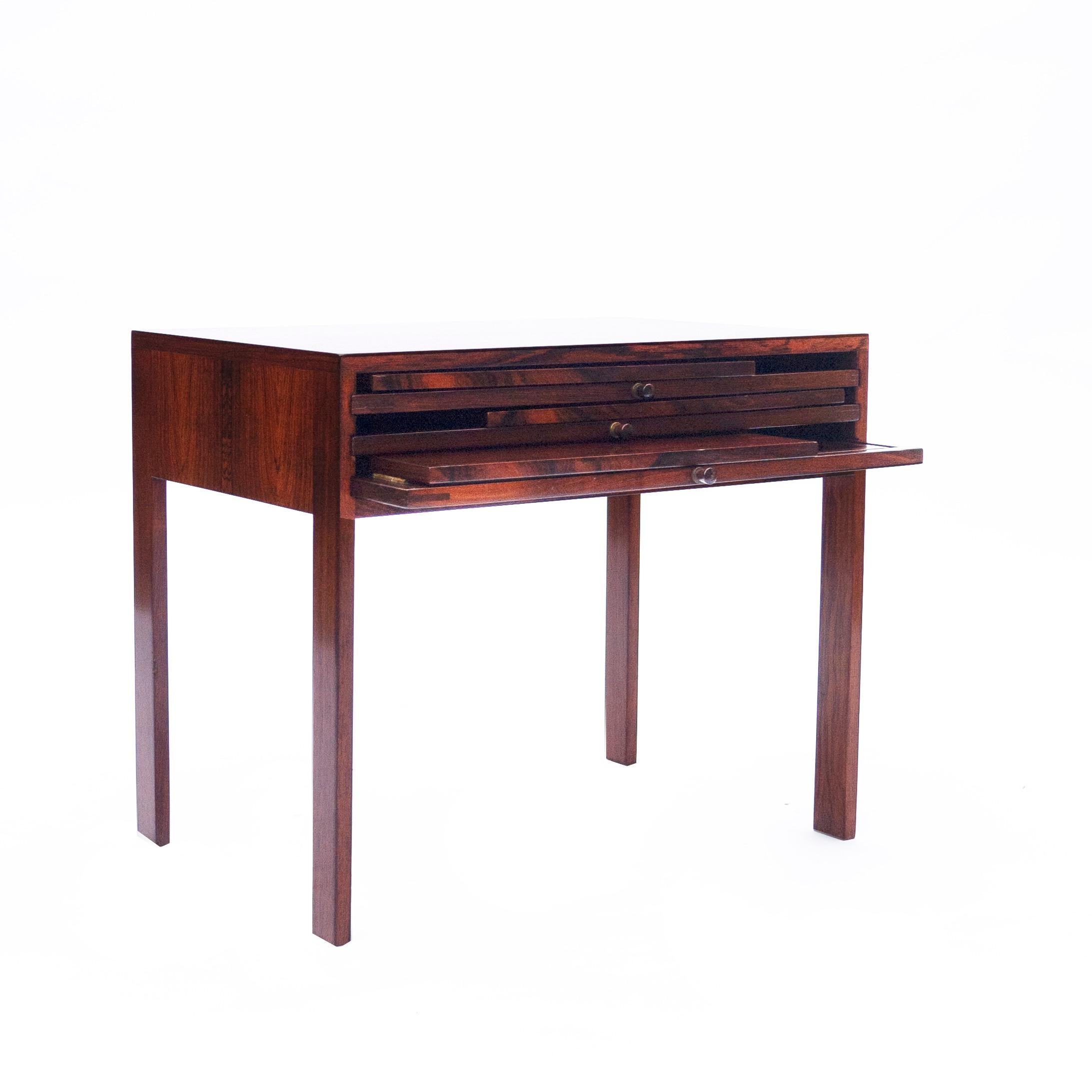 A rosewood side table designed by Illum Wikkelsø with three fold out tables.

Manufacturer - Illum Wikkelsø.

Design Period - 1960 to 1969.

Country of Manufacture - Denmark

Attribution Marks - n/a

Detailed Condition - Good with minimal