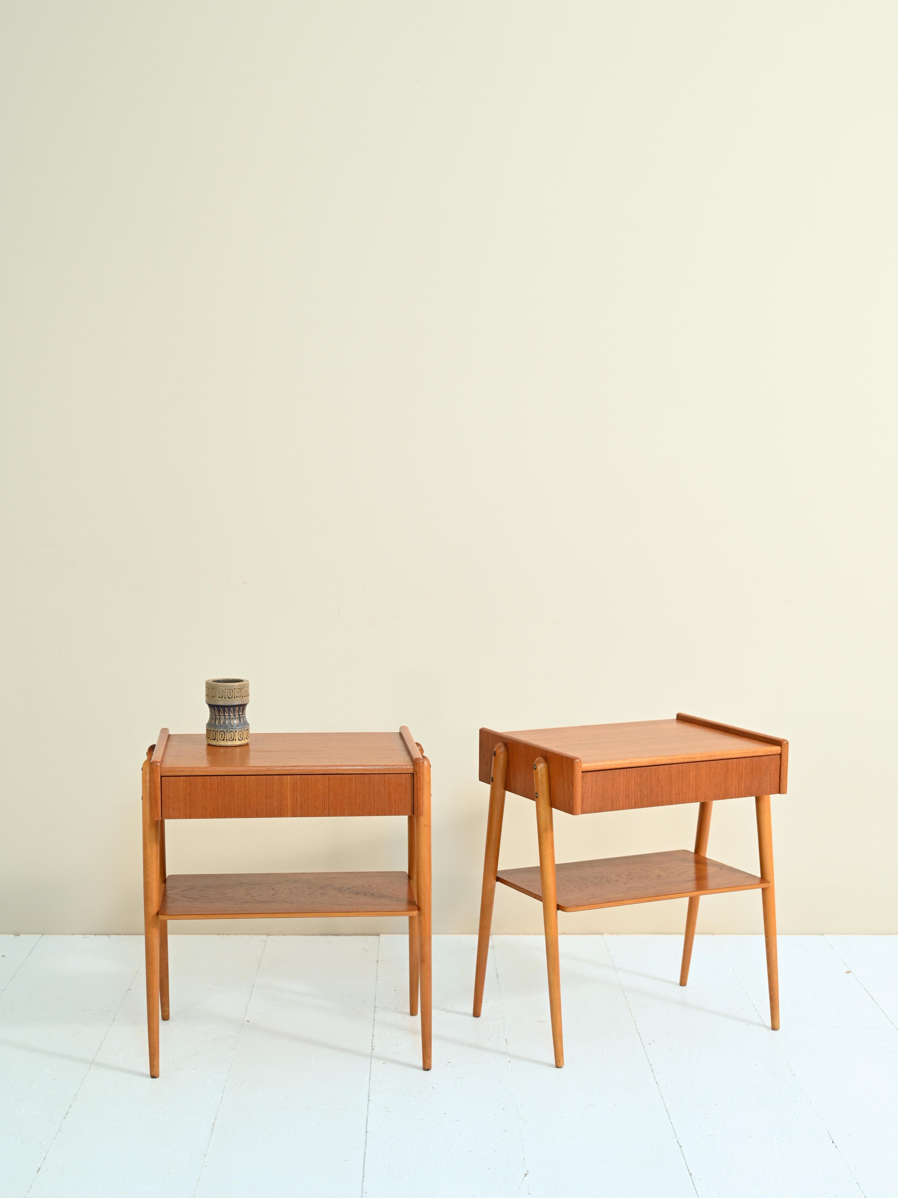 Teak bedside tables with drawer produced by the Swedish company AB Carlström & Co Möbelfabrikn in the 1950s.

A piece of furniture with an original mid-century Nordic design. 

The linear teak wood frame is enhanced by the concealed drawer and