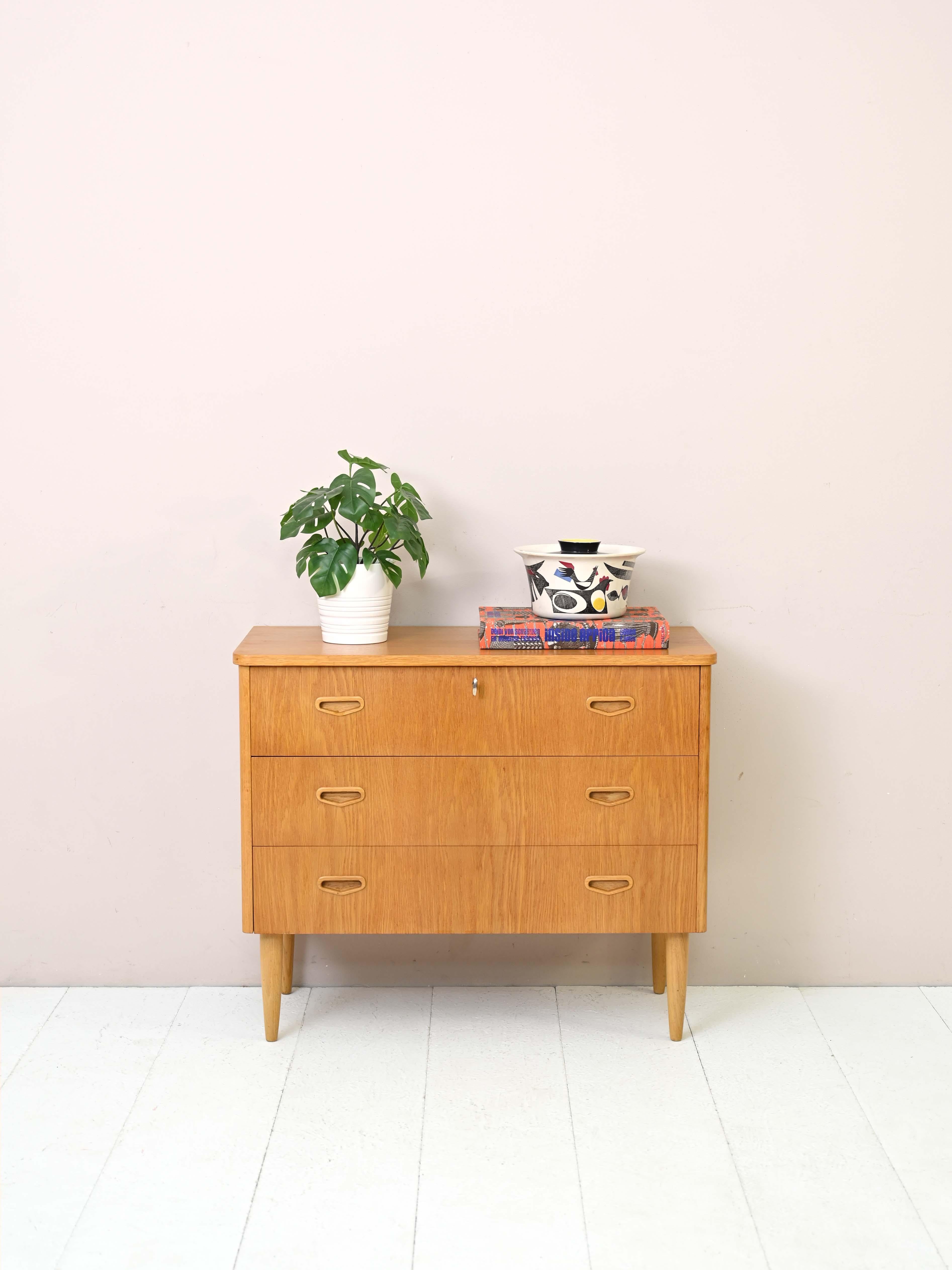 Vintage 1960s cabinet with drawers.
 
This modern-looking chest of drawers traces the Scandinavian taste for simple and functional design. It is characterized by the prevalence of soft lines found in the top with rounded corners, but also in the