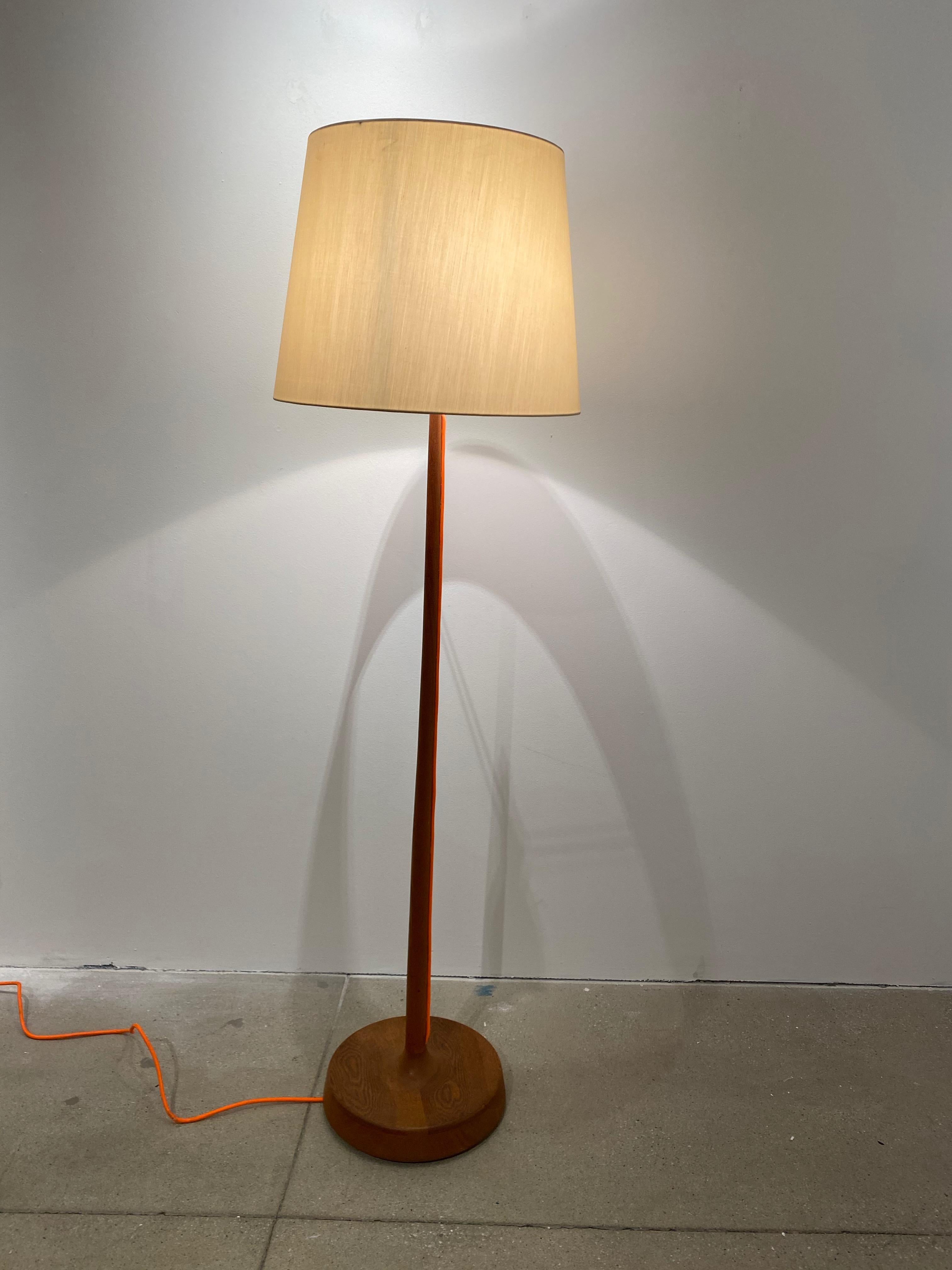 Scandinavian oak floor lamp with exposed orange fabric cord and silk shade. Dimensions of shade are 18