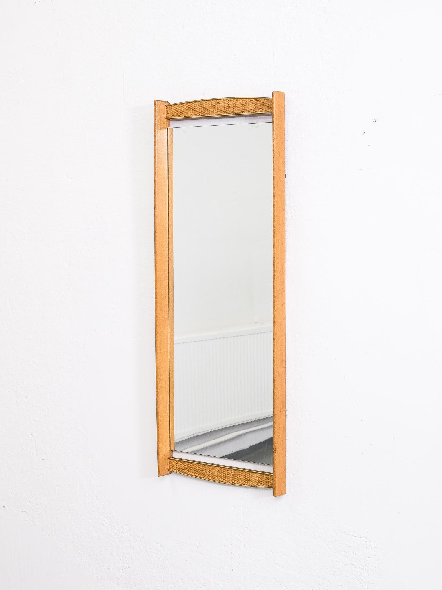 Great quality and stylish Swedish mirror from 1950s. Oak frame with beautiful brass details and cane webbing.