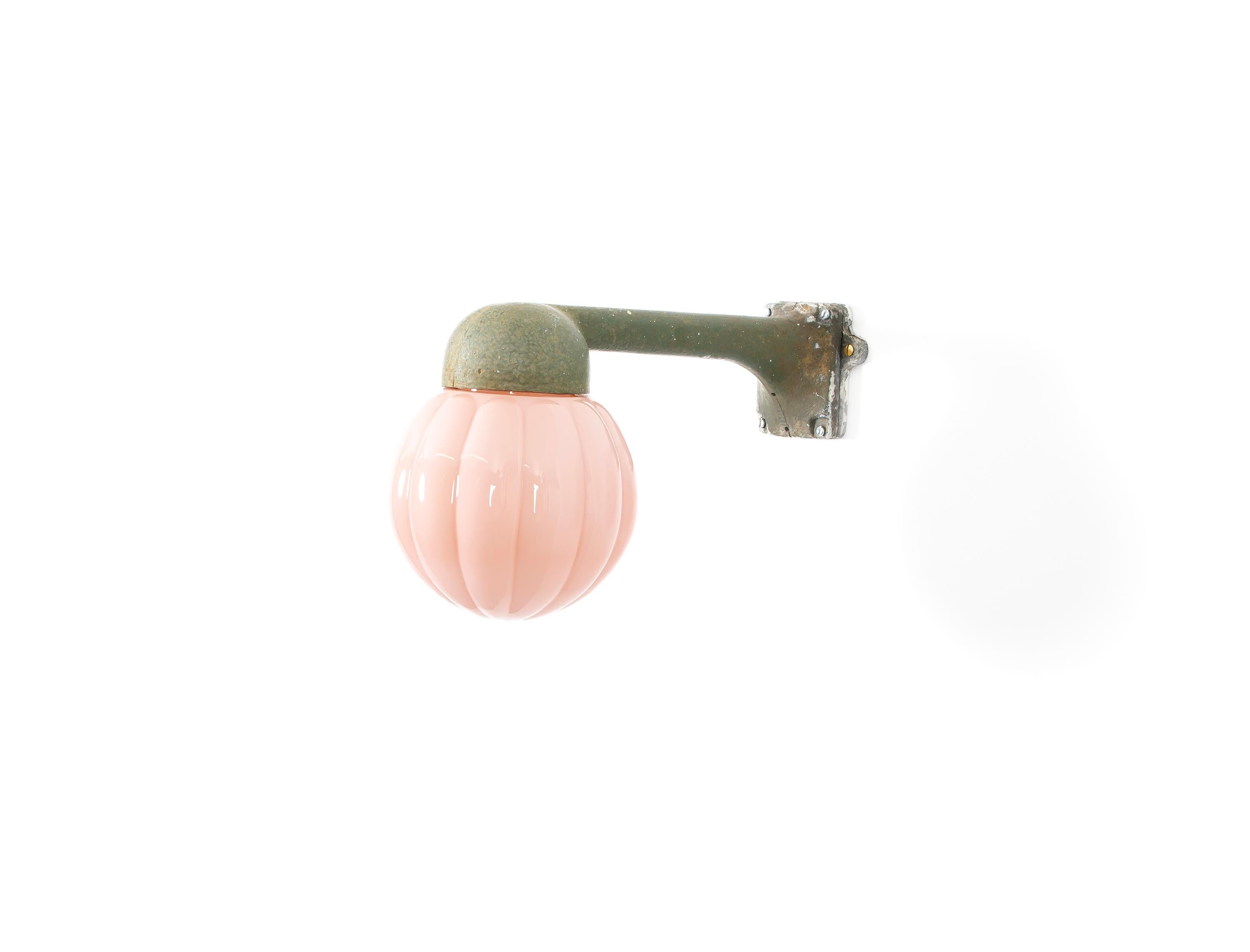 Wonderful and decorative outdoor wall light in a painted metal frame with shade in embossed glass. Designed and made in Norway from circa 1960s first half. The lamp is fully working and in good vintage condition. The lamp is fitted with one E27 bulb