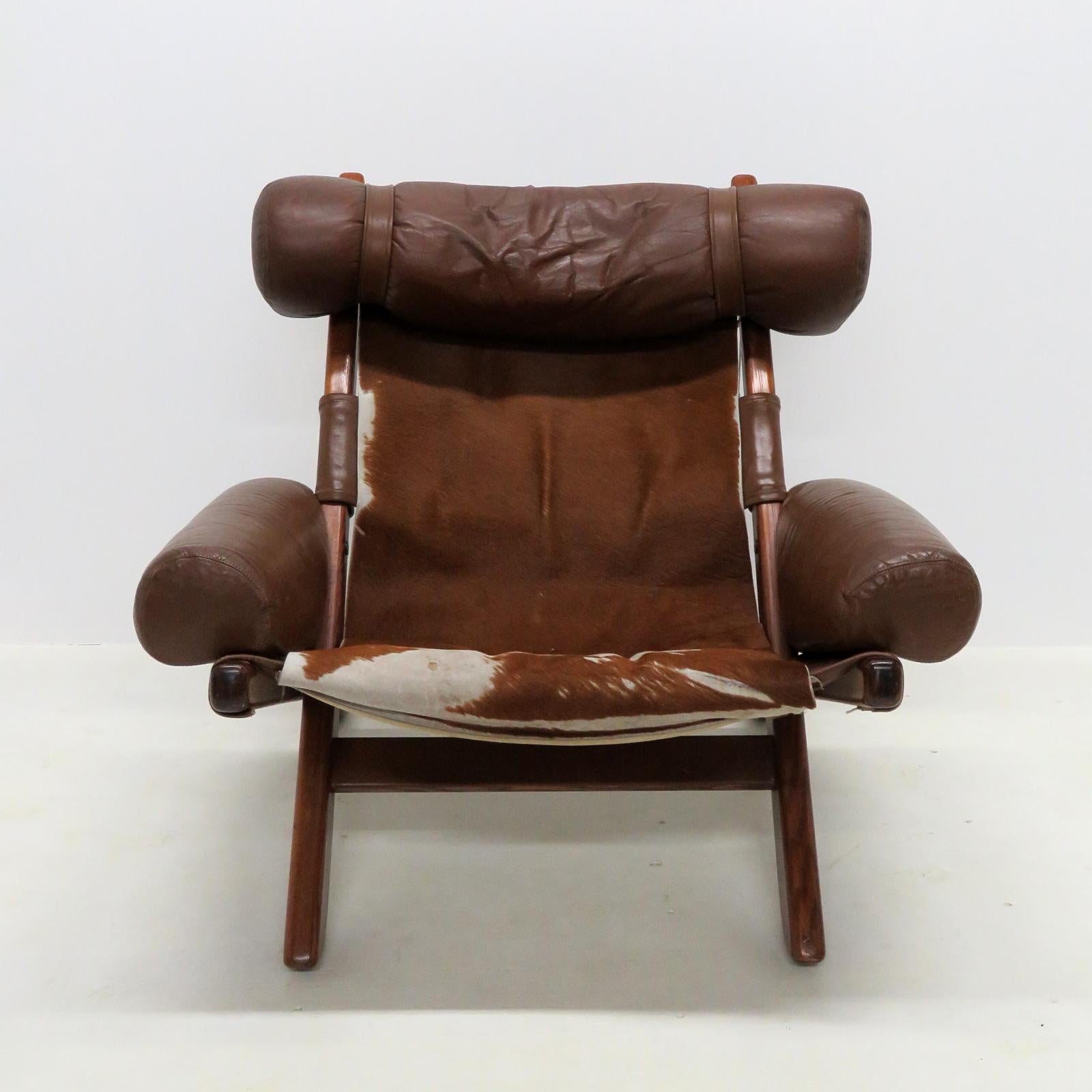 Unique Scandinavian lounge chair from the 1960/70's, with original leather and cow hide upholstery on a teak frame, some wear, stains and minor damage.