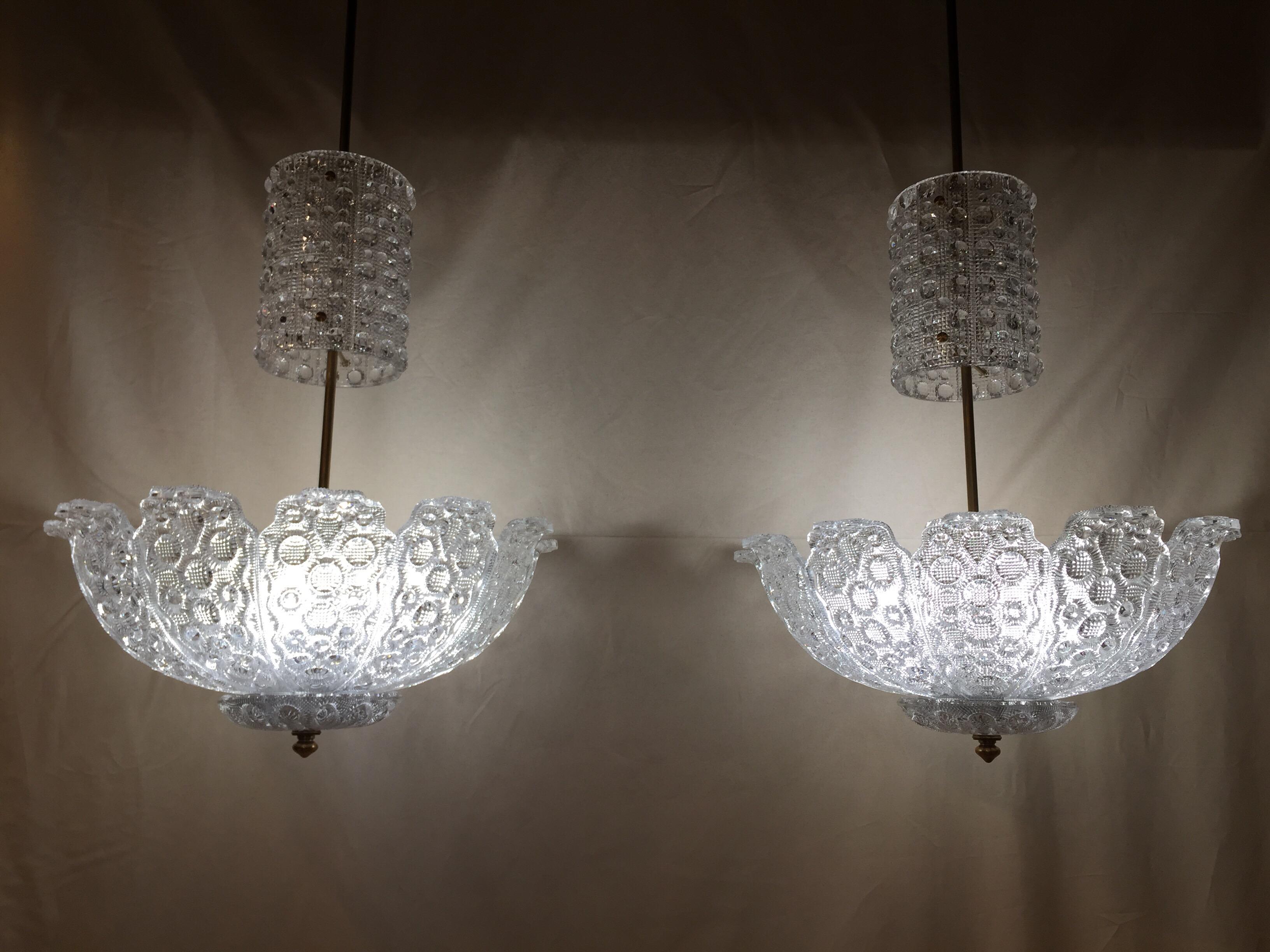 Fabulous Scandinavian big and large chandeliers made in crystal and brass, circa 1940-1950. Flower decor.
Each cup is composed of 12 petals and has three bulbs (see last picture). Both are in perfect condition. 

Measures: Total height up to the