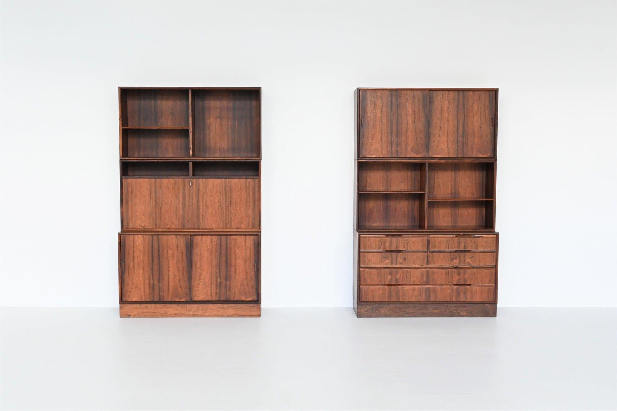 Very nice playful pair of bookcases, wall units or credenzas by unknown manufacturer, Denmark 1960. These beautiful pieces of Danish furniture are very functional with their plenty storage options. The cabinets are made of amazingly grained rosewood