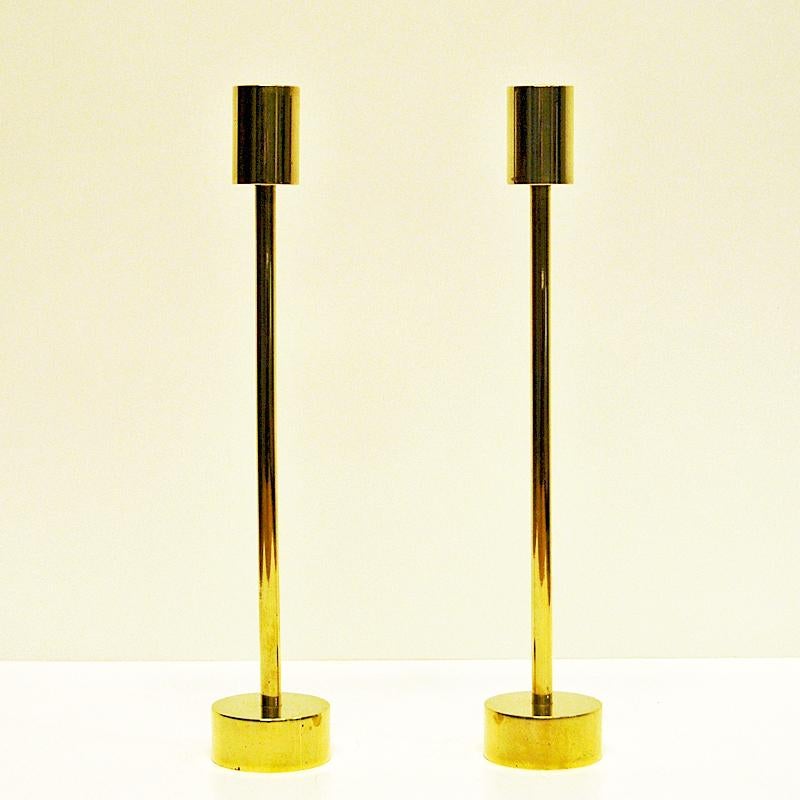 Vintage decorative brass longshaped candlestick holders from around the 1960s for thinner candlelights. Decorative and elegant Classic pair. Diameter 4.5 cm. height 25 cm. Opening on top: 2.4 cm D. Scandinavian design. Good vintage condition.
  