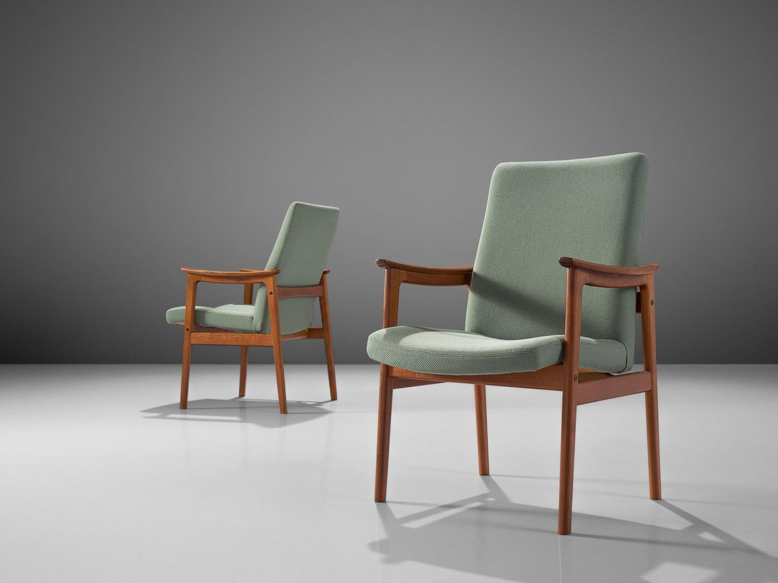 Pair of armchairs, teak, fabric, Scandinavia, 1950s. 

These elegant dining chairs with armrests are both stately and modest. These Scandinavian chairs have a teak frame with a beautiful visible grain. The armrests are nicely shaped in an organic