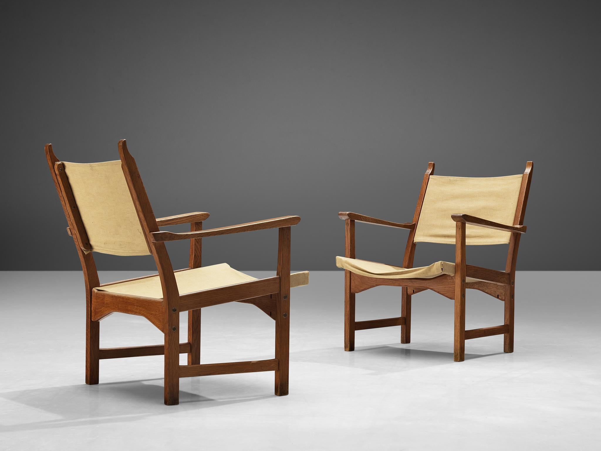 Carl Malmsten and Yngve Ekström for Swedese, pair of 'Caryngo' armchairs, oak, canvas, Sweden, 1955

This Caryngo lounge chair by Carl Malmsten and Yngve Ekström features an oak frame and canvas seating. The linen is securely attached within the