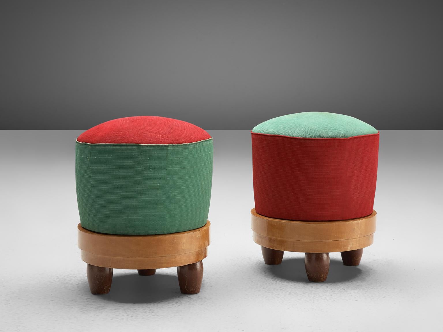 Set of two stools, pine, Scandinavia, 1950s. 

This colorful pair of stools brightens up your interior. The stools have a playful design, with short bulky, rounded feet and a combination of red and green fabric. The seat is cylinder shaped and the