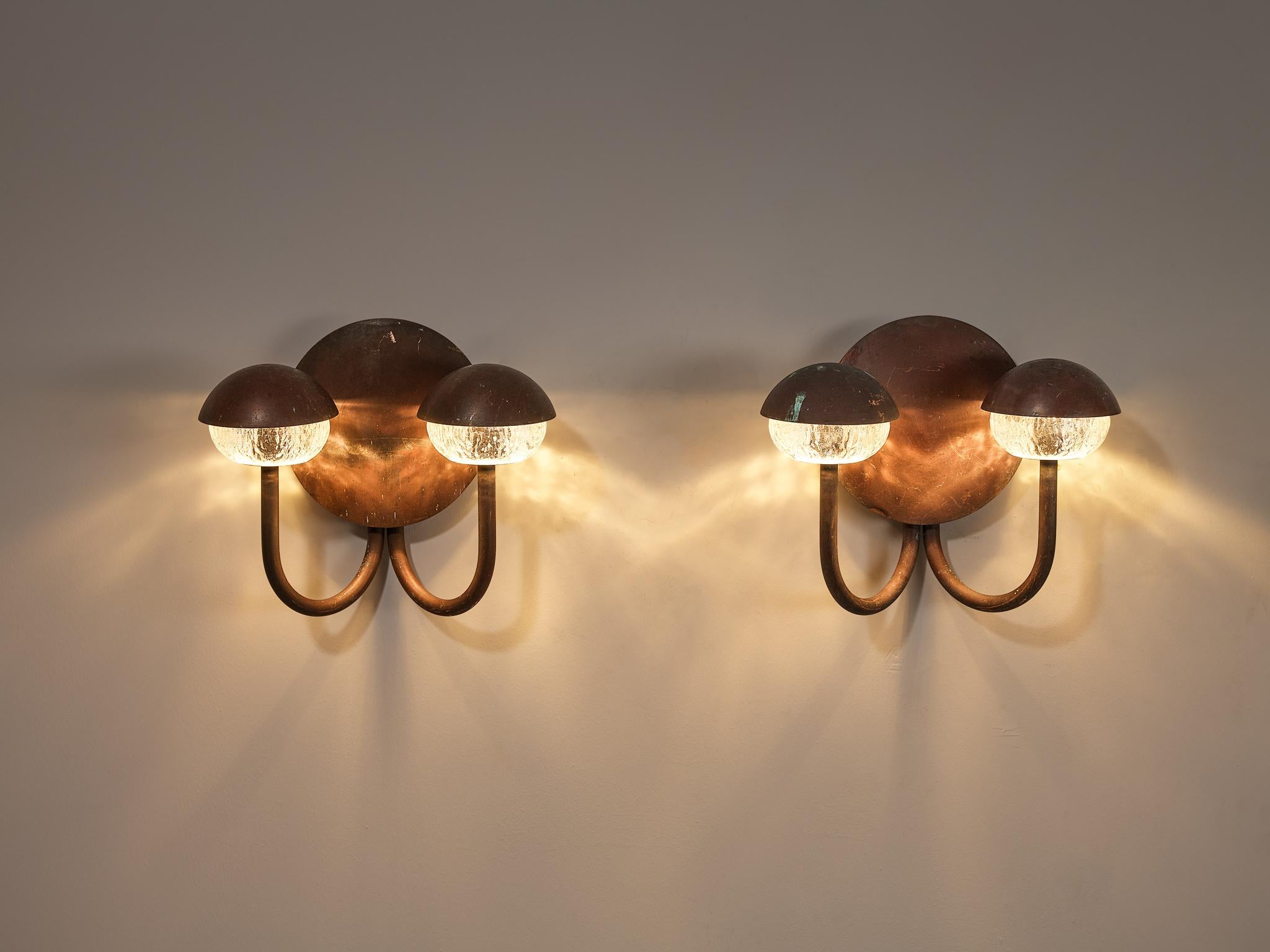 Pair of wall lights, patinated copper, glass, Scandinavia, 1960s

Charming pair of wall lights executed in copper with a ribbed glass shade. The lamp consists of a circular wall plate from which two copper curved arms with the textured light bulbs