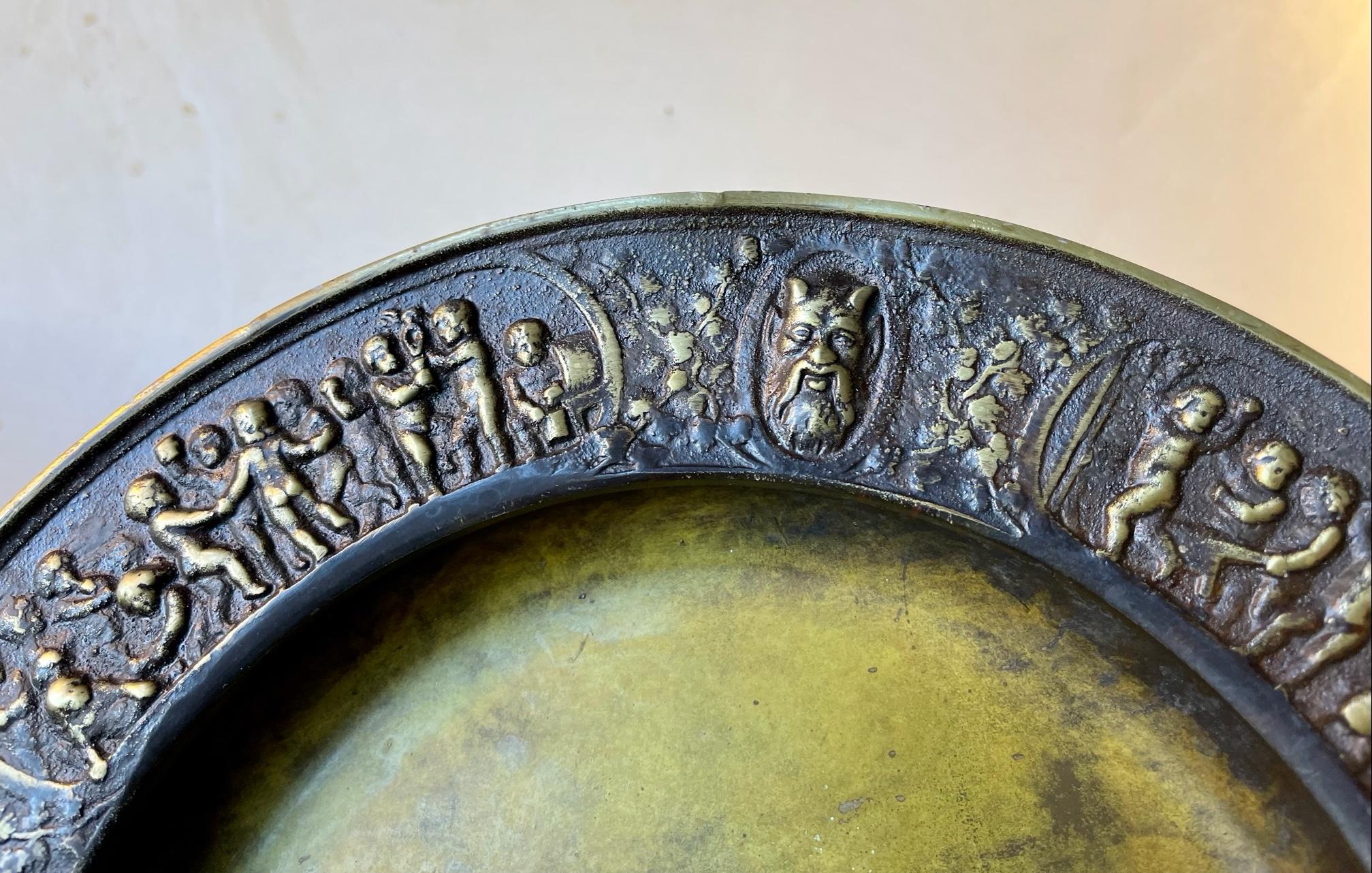 Unusual Cast bronze dish with green verdigris patina. It features scenes from the old testement with depictions of Lucifer - Satan cast in relief around its perimeter. Signed to its back: Memories from Sepstrup in Danish. Sepstrup is a small town in