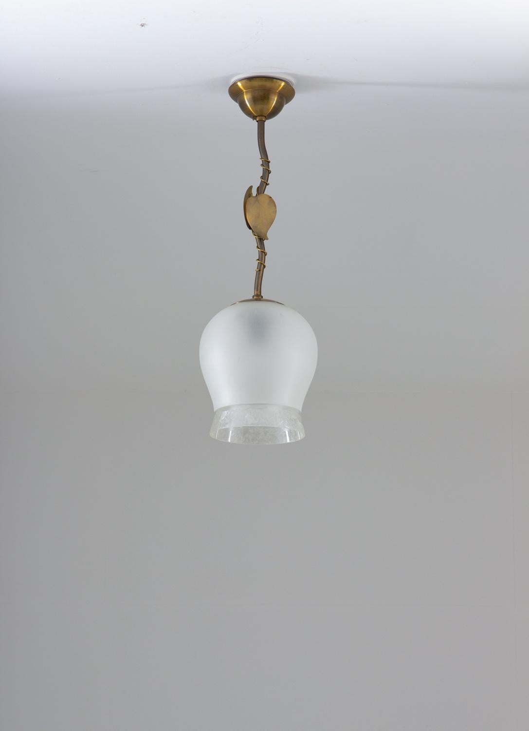Elegant pendant in brass and frosted glass produced in Sweden. 
The frosted glass gives a beautiful and soft light and the brass parts have a nice natural patina.
Condition: Good original condition with patina.