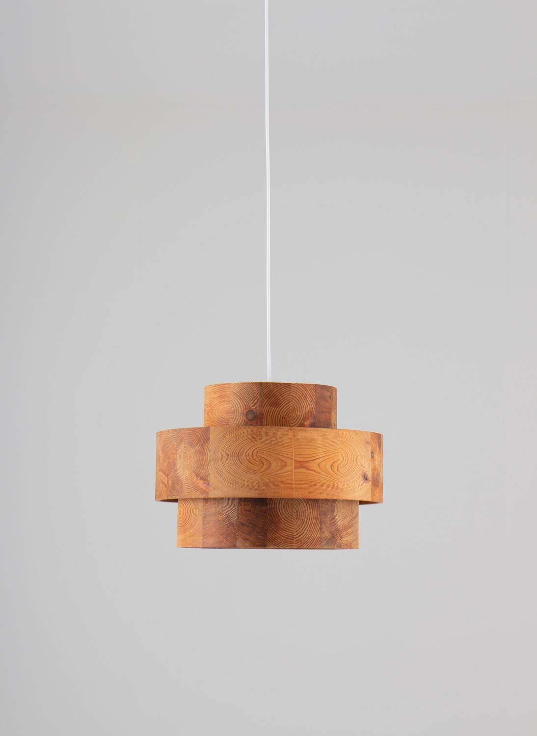 A beautiful pendant by Kentson Produkter, Sweden circa 1970. 
The lamp consists of three cylinders made of pieces of curved pine, creating a spectacular pattern.

Condition: Very good original condition.