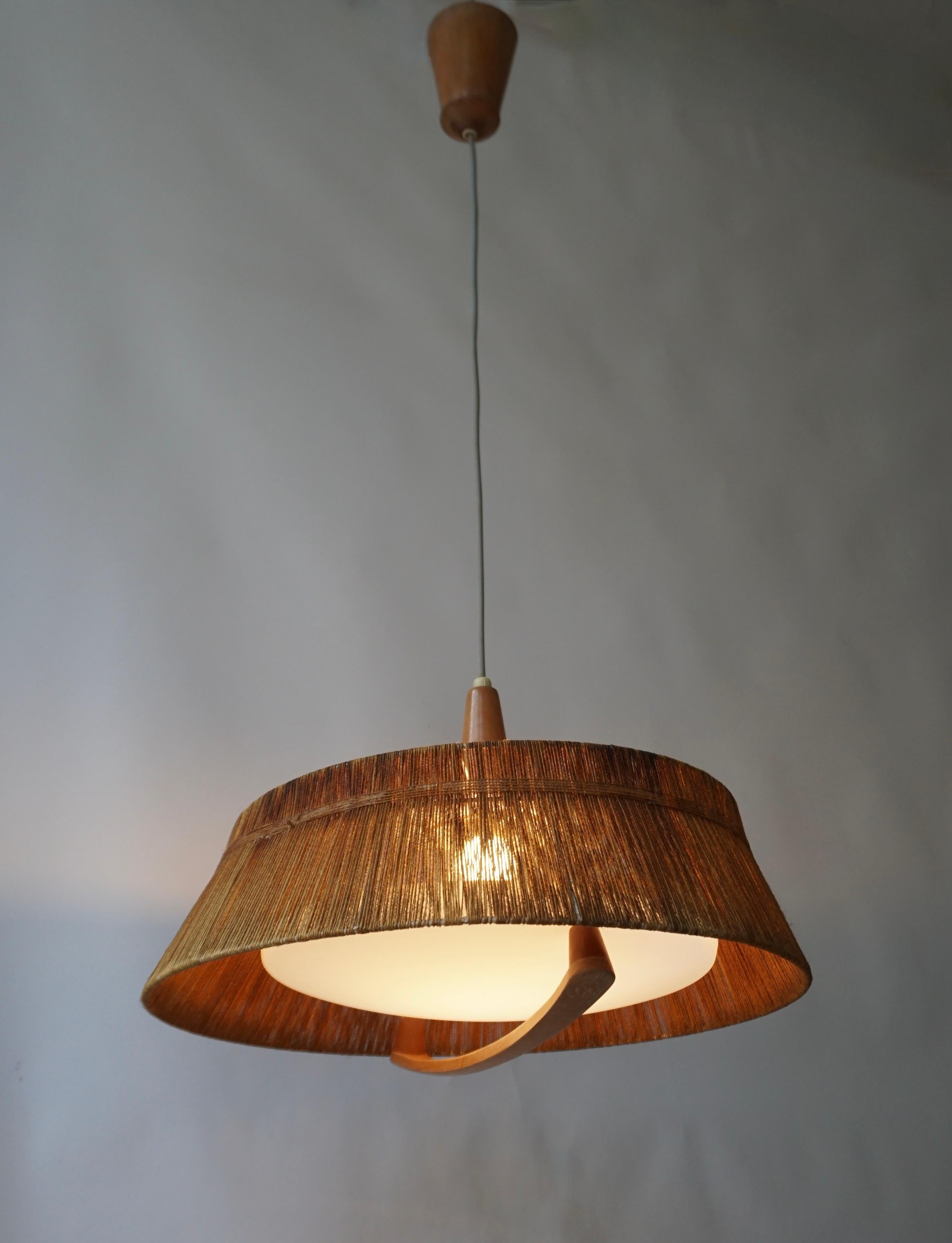 Large Scandinavian style pendant light from the 60s.
Metal frame with jute rope, plastic light cover and wooden parts.

The lamp has one sockets for incandescent lamp with screw base or E27 type LEDs. It is possible to install this fixture in all