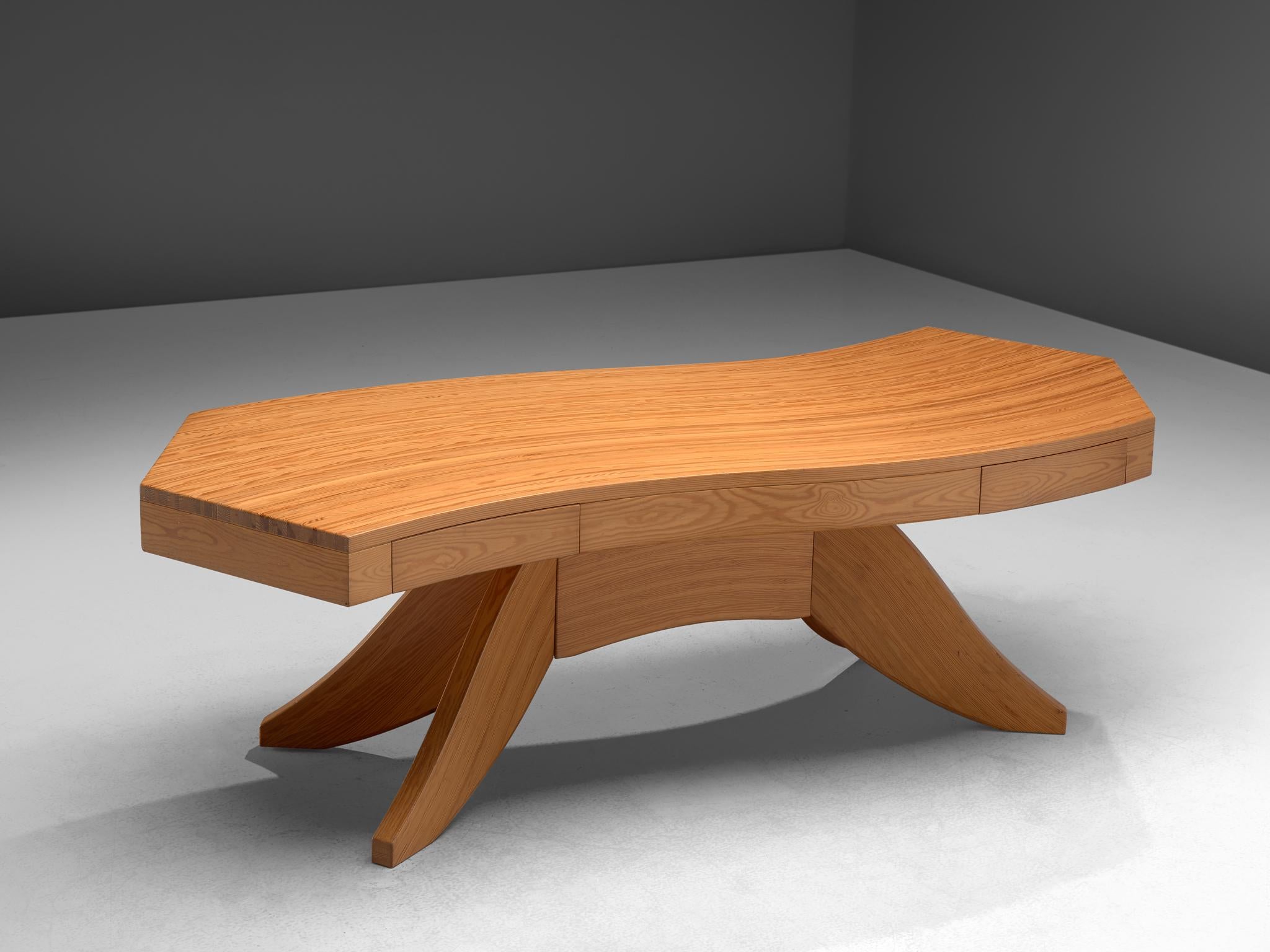 Writing table, pine, Scandinavia, 1960s.

Stunning biomorphic table with a waved table top. This writing table features a waved wooden top, made out of tangentially-sawn pine slats. Two drawers are included in the table top. The centered leg