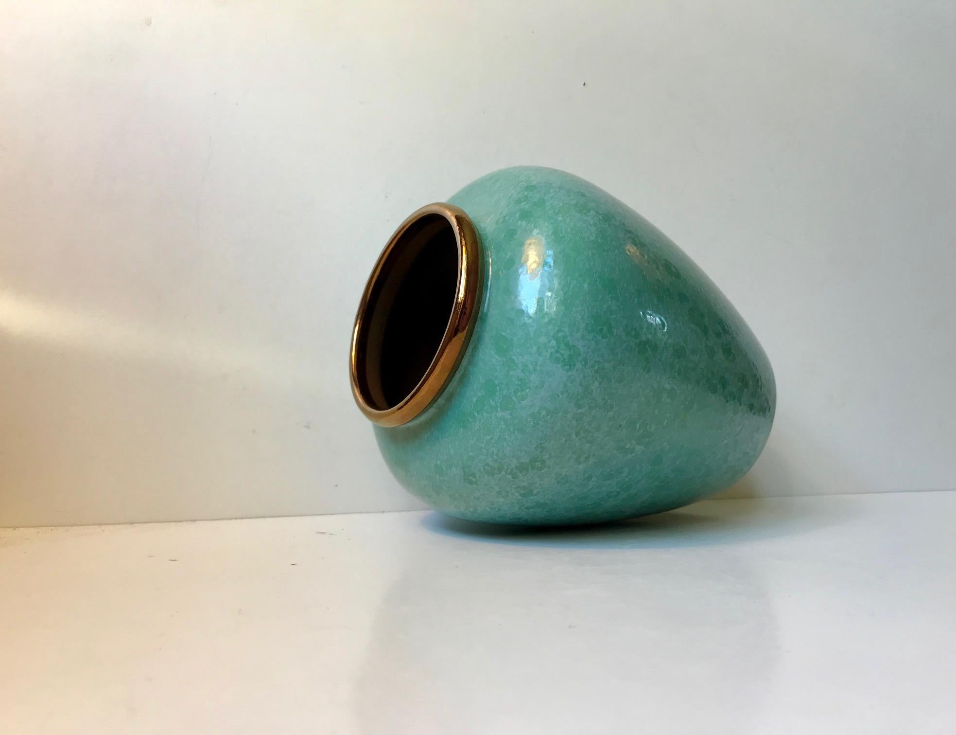 - Large baluster shaped vase or urn 
- Cloudy speckled green glaze and an edge with copper/bronze glaze
- Anonymous Scandinavian maker in the style of Ewald Dahlskog - Bo Fajans.