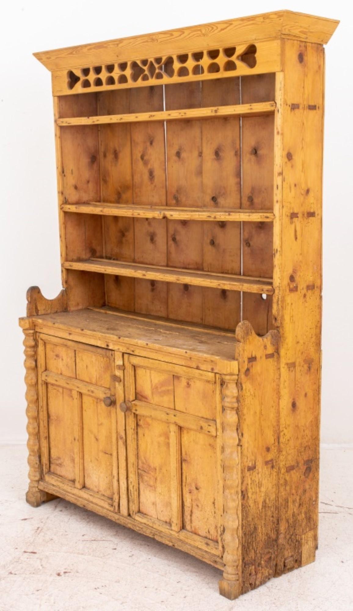 Scandinavian Provincial Style Pine Cabinet and Hutch, made of reclaimed antique pine, with cornice above a reticulated frieze, the hutch with three shelves above a two-door cabinet. Provenance: Property from a Fifth Avenue duplex. 

Dealer: S138XX

