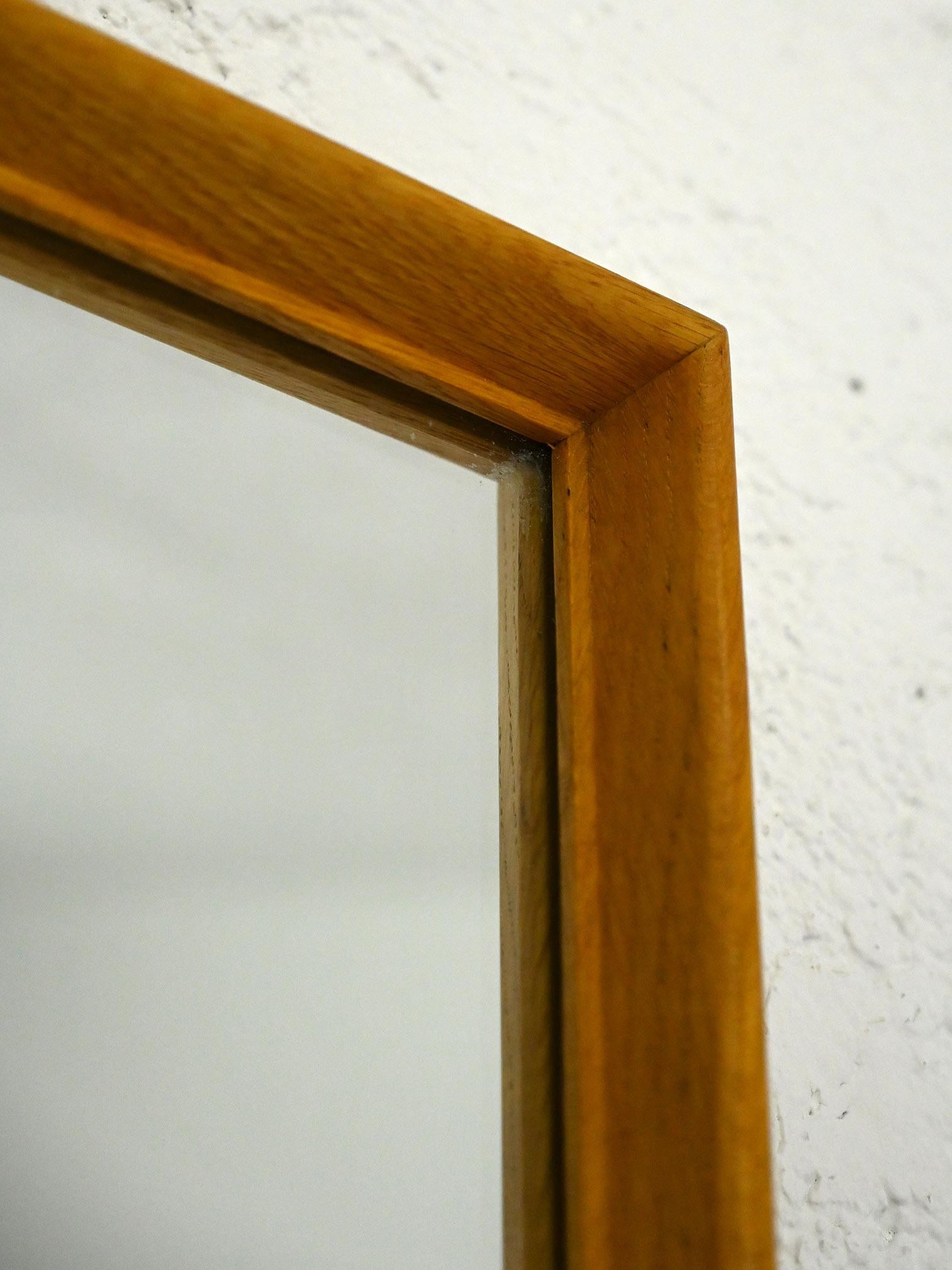 Original 1960s vintage mirror.

With a sleek, minimalist design, this mirror made of teak wood stands out for its clean, modern lines. The rectangular shape makes it a perfect addition as a wall mirror, fitting beautifully in the entryway or other