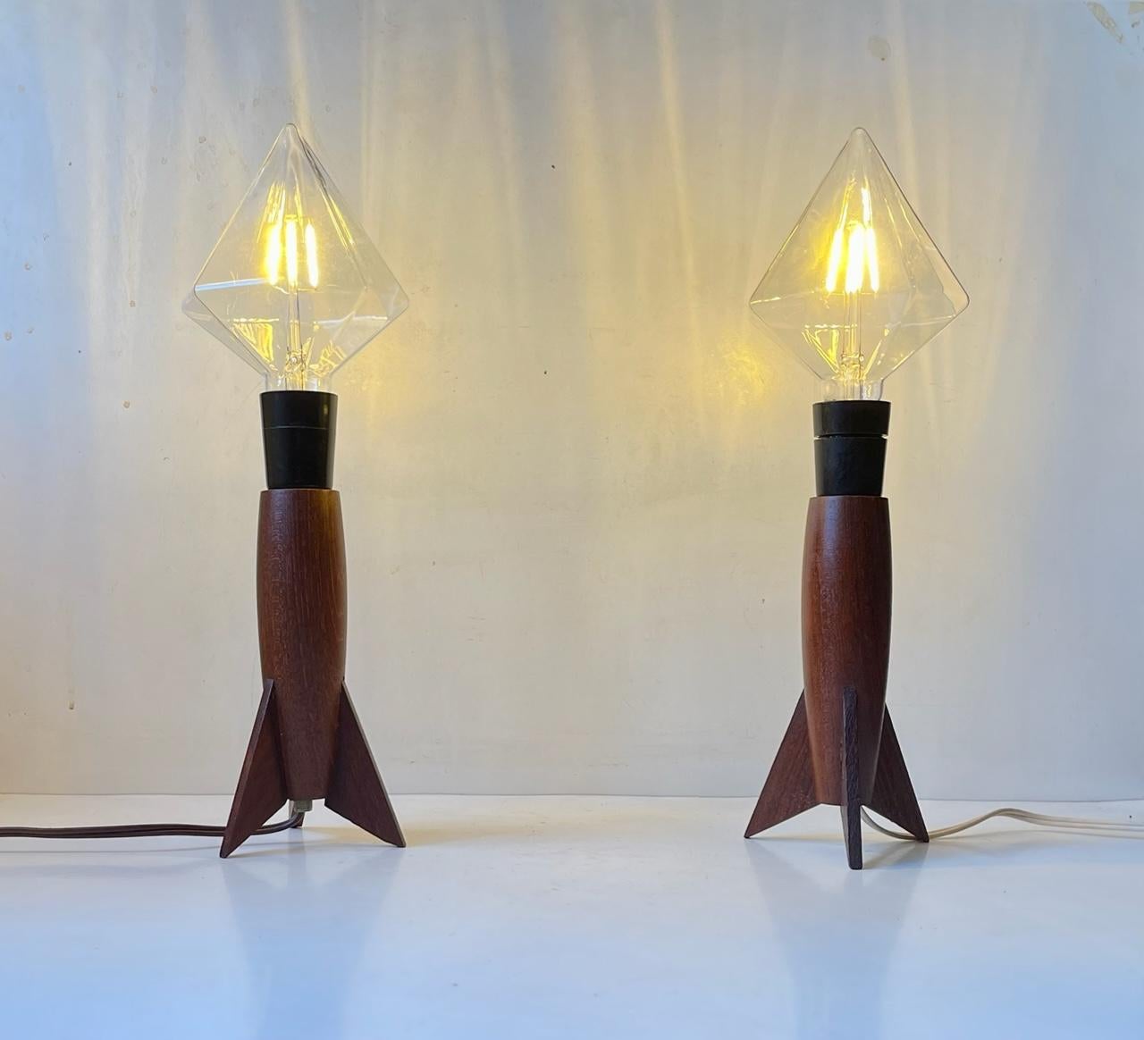 A matching pair of rocket shaped table light. They are made from teak and mounted with newer conical everlasting jumbo bulbs. The bases were made in Scandinavia, probably Denmark, during the 1960s or 70s by a trained carpenter or furniture maker.